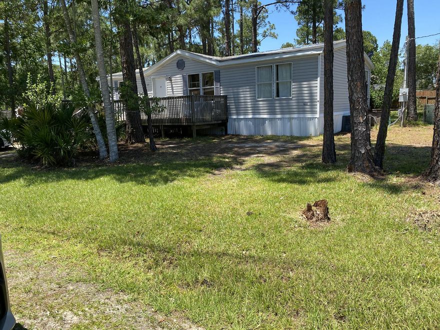Location, Location, Location! Great property in Santa Rosa Beach for under $130K! Located within a Highly desired neighborhood, this home is Nestled in between pine trees and beautiful, palms with gorgeous brand new homes all around!Built in 1999 this manufactured home features 3 bedrooms, 2 bathrooms with a split Master and a large master suite with a walk-in closet. Enjoy your serene, backyard oasis with the wood deck and huge yard big enough for a swimming pool! Front deck is handicapped accessible and includes a shed for all of your yard tools or make it your She-Shed!With minimal investment this home could be yours! Then place it on Air BNB or rent it out for long term. Rentals in this area start anywhere from $1600 and up. Quick access to the bay, the beach and walk to Walmart