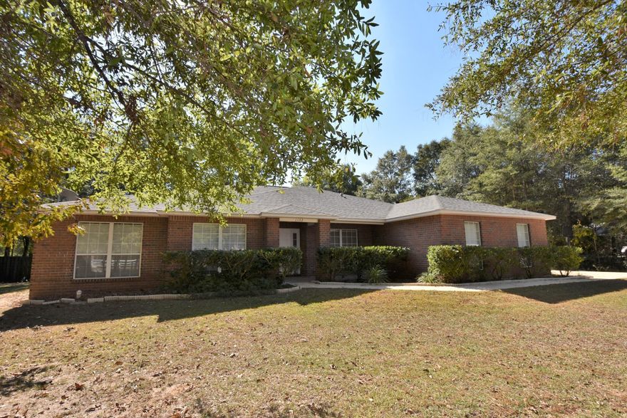 Enjoy the peaceful, country living of this home and neighborhood in Baker! Home is situated on a Level 1 Acre w/lots of trees and a shady back yard! PLUS...a Covered Porch, HUGE Open patio and Stone Walkway to the Koi Pond. Privacy Fenced back yard has a very private and tranquil setting and even a yard building for all of your tools! Over 2,500 sq.ft. w/4 Bedrooms, 2 Bathrooms, Office/Den, Eat in Kitchen, Formal Dining, and Great Room with a view of the Outdoor space! Split Bedroom design has a SECLUDED Master Suite which has access to the Covered Porch. Master Bath has a double vanity, TWO Walk-in-closets, soaker tub, and separate shower! Seller is offering a Home Warranty and Closing Costs Assistance! Schedule your PRIVATE Viewing TODAY! Click MORE for additional info.