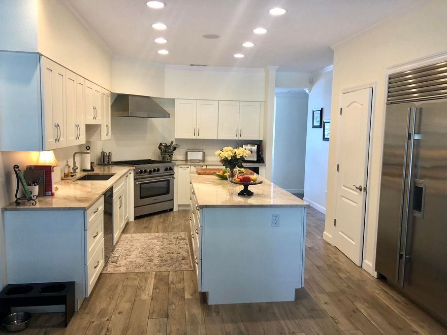 This newly remodeled single-story brick ranch home is perfectly situated on a large .62 acre corner lot that also backs up to Indian Bayou Golf Course. With two living areas, a separate dining room, three spacious bedrooms and a separate office in the garage, there is room to spread out. A screen enclosed, solar heated pool along with an outdoor brick oven is the perfect place to cook out and cool off on long summer afternoons. Newly remodeled, you will enjoy cooking in the gourmet kitchen complete with a six-burner gas stove and Sub-Zero refrigerator. Other notable features include ceramic wood tile floors, plantation shutters, new paint, whole house generator, wood burning fireplace, and invisible fence and more.