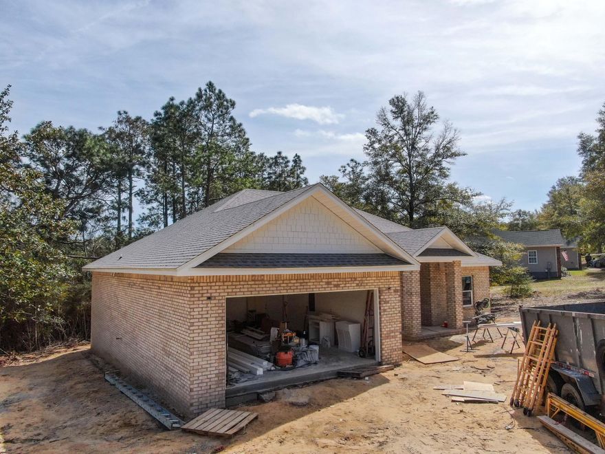 This is NOT your average new build. This brick home has many noteworthy custom, high end features with split plan, 4 beds/2.5 baths, covered porch and 2 car garage. The foyer's barrel vault pine ceiling sets the stage for the exceptional craftsmanship and continues to the tongue and groove cathedral ceiling in the living and kitchen. The all white kitchen features quartz counters and the latest high end stainless steel appliances and a nearly 13' long island, ideal for everyone to gather comfortably. Premium luxury vinyl plank and tile flooring throughout (no carpet) is ideal for easy maintenance. The master suite features large windows, trey ceiling, 5' tile shower, double vanity, and soaking tub. The only thing missing from this home is you. Estimated completion end of March 2023.