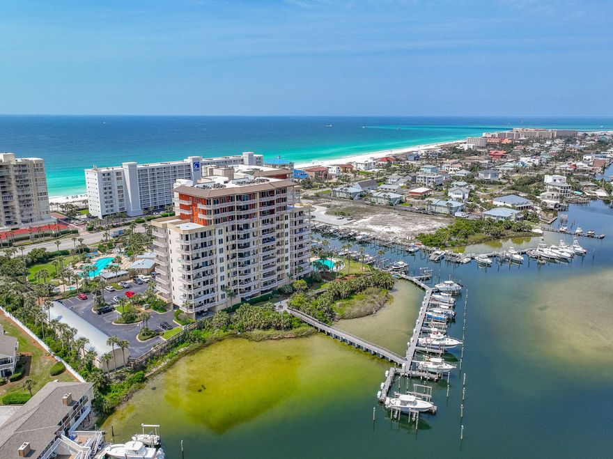 Indulge in a luxurious coastal lifestyle by living right on the Destin Harbor. Easy boat access and deeded gulf access just across the street. Unit 702A offers breathtaking harbor views, from its expansive patio, that stretch all the way to the Destin bridge. Immerse yourself in the feeling of home with 2377 square feet of living space, 10-foot ceilings, crown molding, and luxurious granite countertops. The open floor plan enhances the flow and spaciousness of the unit, while the assigned covered parking and exterior storage room make it a practical and a convenient choice. The high-end furnishings elevate the unit's charm and appeal, and it's also Short-Term Rental Friendly, if desired. Don't miss this opportunity to own this exquisite gem!