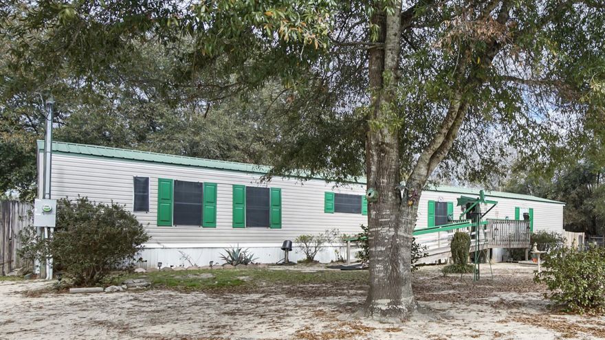 Welcome to this well-maintained 3 BR, 2 BA manufactured home! The property is located on a paved road and encompasses two lots, totaling nearly half an acre. This home features a welcoming front porch, a perfect spot to relax with a cup of coffee. While the majority of the home showcases classic carpet flooring, the eat-in kitchen has been recently refreshed with vinyl plank flooring. Exiting the back, you'll find a cozy back porch and a 16'x16' building with a metal roof that can serve as a workshop or hobby space. The spacious backyard is fenced, providing a safe space. This mobile home has never been relocated from its original setup. Whether you're looking for your next home or an investment property, come see the warmth and charm this home has to offer!