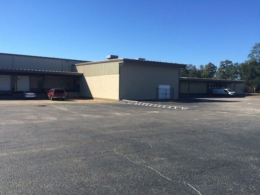 High volume industrial center situated on 13+ acres that encompasses a 105,478 SF Building has 28,000 SF Distribution/Manufacturing Warehouse with approximately 1,250 SF climate controlled office space available. Climate controlled office has mezzanine storage above, common men's and women's handicap accessible restrooms. Features: 4 - 8'x10' roll up doors (3 dock high and 1 grade level with ramp) and covered loading dock. Additional out building with approximately 3,000 SF had additional roll up and grade level ramp. Rear roll-up door for access and ventilation; 2 wall-cut vent fans. Open floor plan space with 25 FT centerspan and 22 FT eave height. Floors are commercial grade concrete.