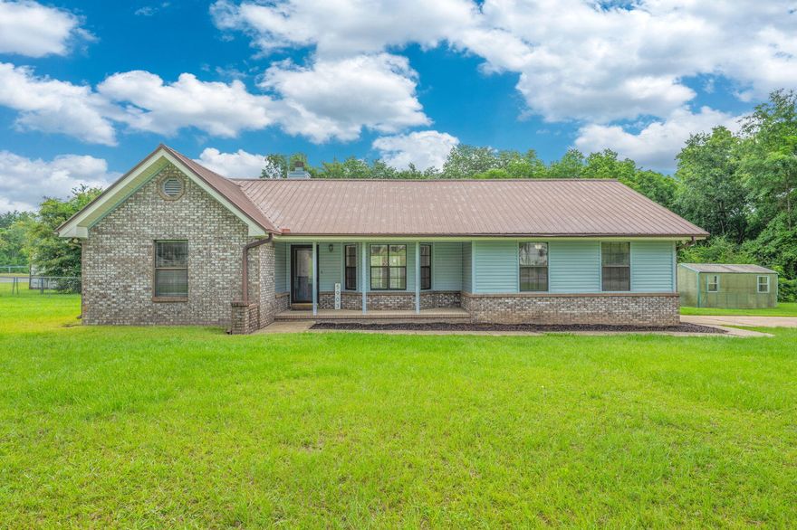 Tucked away on nearly 2 acres of serene land, this charming single-family home offers the perfect blend of rustic warmth and updated convenience. Step inside to a cozy living room featuring a stunning stone fireplace that burns both wood and gas--ideal for creating the perfect ambiance year-round.The thoughtfully designed split floor plan ensures privacy and functionality, while the kitchen is a cook's dream with a gas stove, updated stainless steel appliances, and plenty of space for gatherings.Enjoy the freedom of wide open spaces with a large deck perfect for entertaining or quiet mornings overlooking the partially fenced backyard. Additional updates include a new HVAC system and water heater installed in 2020, giving peace of mind and energy efficiency. Roof- All screws and washers were recently replaced and sealed including new skylights. 4pt and Wind mitigation available in the documents. 
Experience the best of both worldspeaceful country living with convenient access to nearby schools, grocery stores, restaurants, banks, and the post officeall just minutes away. (Storage container will be removed)