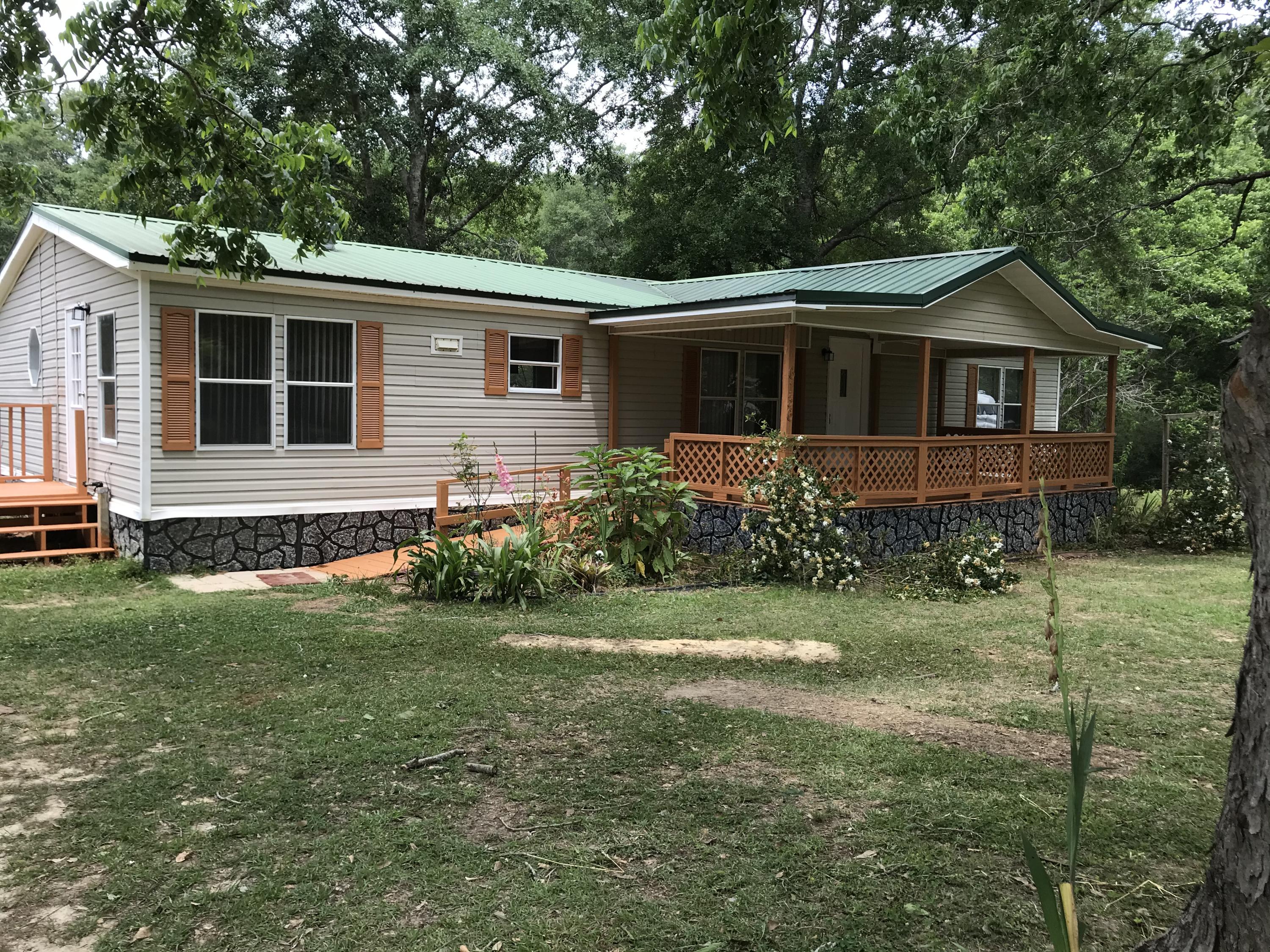 Country living done right. Located behind Baker School. This nicely remodeled 4 bedroom 2 bath Mobile Home is surrounded by large Pecan Trees. New tile in living room and kitchen. Laminate flooring in all four bedrooms. This is a wonderful split floor plan. Large master bed room with its own private bath. Master bath had over sized tub, separate shower, and private potty room. Very large living room opens into roomy kitchen with lots of cabinets for storage and all new appliances. Small breakfast nook or mudd room just off the kitchen. The other 3 bedroom are on other end of home with a shared full bathroom.