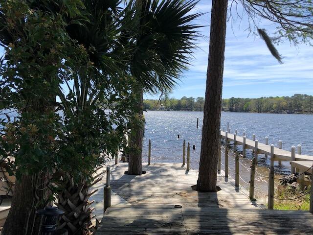 Showings begin with an OPEN HOUSE on Sunday, March 27 from 1:00 - 3:00 p.m. Make your dream come true! This is the home you've been waiting for. Come see this beautiful waterfront townhome in the much sought after community of Water Oaks. The home has been freshly updated with new luxury vinyl plank flooring throughout the main floor and new carpet upstairs. Fresh paint throughout, beautiful quartz countertops appropriately named ''white sparkly'', new subway tile backsplash and stainless appliances are just a few of the renovations (please see supplemental document sheet listing all pertinent information.) Enjoy sweeping views of the Boggy Bayou from both the living area and your master suite. Beautifully situated among mature oak, magnolia and cypress trees the property also has