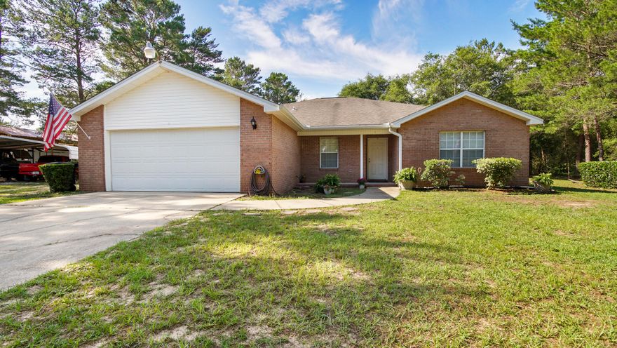 MOVE IN READY 4 bedroom/ 2 bath home situated on 5 acres. Home features wood laminate flooring with exception of 2 bedrooms, flex room for possible office, kitchen pantry, fireplace, large back patio perfect for entertaining, and a chain-linked fenced backyard ensuring privacy. Enjoy the convenience of a 24x48 Pole Barn with 14-foot clearance and a 30x40 Quonset Hut-style steel building equipped with a 200 amp breaker. Newer roof (2013) and HVAC (2019) will give you peace of mind. Just a short distance from Mossy Head Park and convenient to I-10 and South Walton Beaches. This home combines comfort with functional living. If you love to unwind after a busy day, take a ride through the trails for peace and quiet. Home is ideal for anyone looking for ample space and efficient amenities.