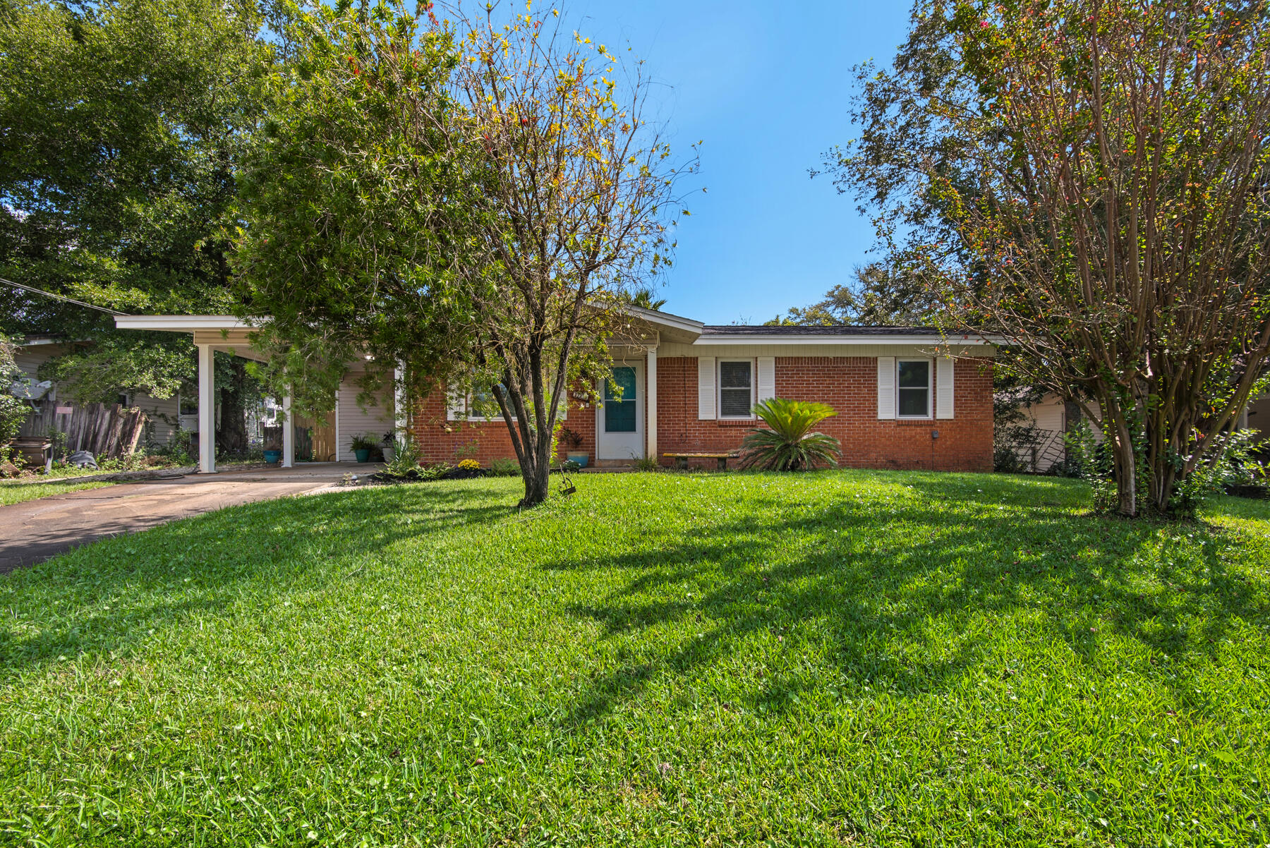 This is a beautifully updated home! Featuring stylish rectangular tiles throughout, the open floor plan seamlessly connects the dining, living, and kitchen areas, creating an inviting space perfect for entertaining. The generous laundry area boasts extra storage, adding to your convenience. Step outside to your serene covered back porch, ideal for relaxation, and discover the additional workshop or man/woman cave?. Perfect for hobbies or retreat. Plus, with a handy yard building for all your outdoor needs, this property truly has it all. And pet lovers rejoice! - cats and dogs up to 50 pounds are welcome here!