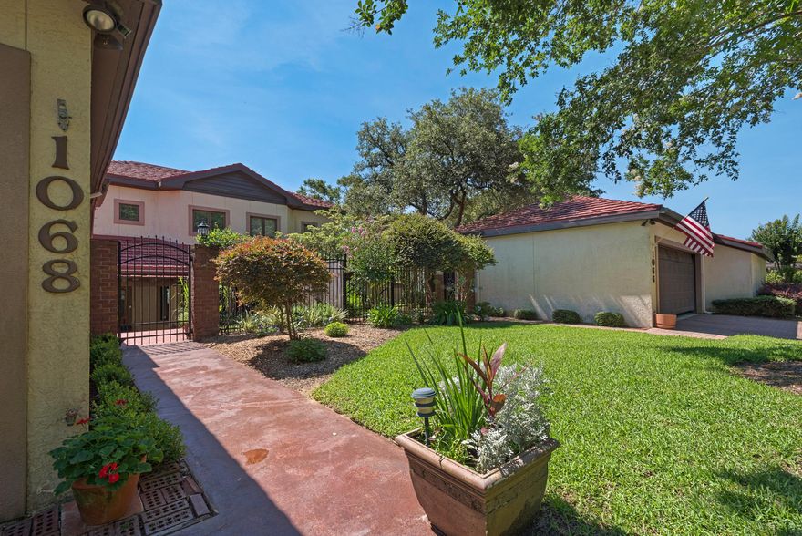 Gorgeous Lake Views! Private and peaceful living awaits you with stunning architectural details that maximize the breathtaking views of the Henderson Lake and Rocky Bayou Golf Course from almost every room. This 2 bedroom, option 3 bedroom/currently used as an office is designed so everyone has their space and plenty of it. The entry through the gated courtyard over the brick paver walkway sets the tone for this fantastic stylish townhome. The master bedroom is on the main level, very generous in size, wood laminate flooring with a private balcony to enjoy your morning coffee while watching the turtles on the lake. A custom barn door welcomes you to the enchanting master bathroom, recently remodeled with tile-surround double sinks, granite counter tops, private potty closet, solid wood