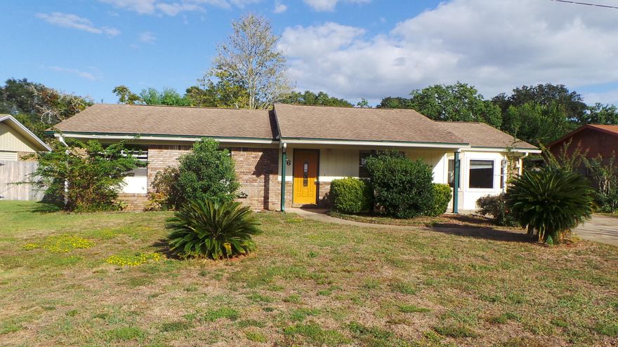 Very nice three bedroom, two bathroom home only 15 minutes from beaches and parks. This home offers living space as soon as you enter, and that living space steps down into an additional living space but would make a great office, kids play room, or man/woman cave. Separate laundry space. Kitchen has eat-in space as well as formal dining, stainless dishwasher, tile floors and backsplash. Tile floors in both bathrooms, as well. Awesome sized, privacy fenced backyard with yard building. Covered patio, made from a wood-walled pergola, offers plenty of shade from the sun. Home is also close to restaurants, and less than 5 minutes away from Shalimar Elementary School. Call today as this home will not last long!