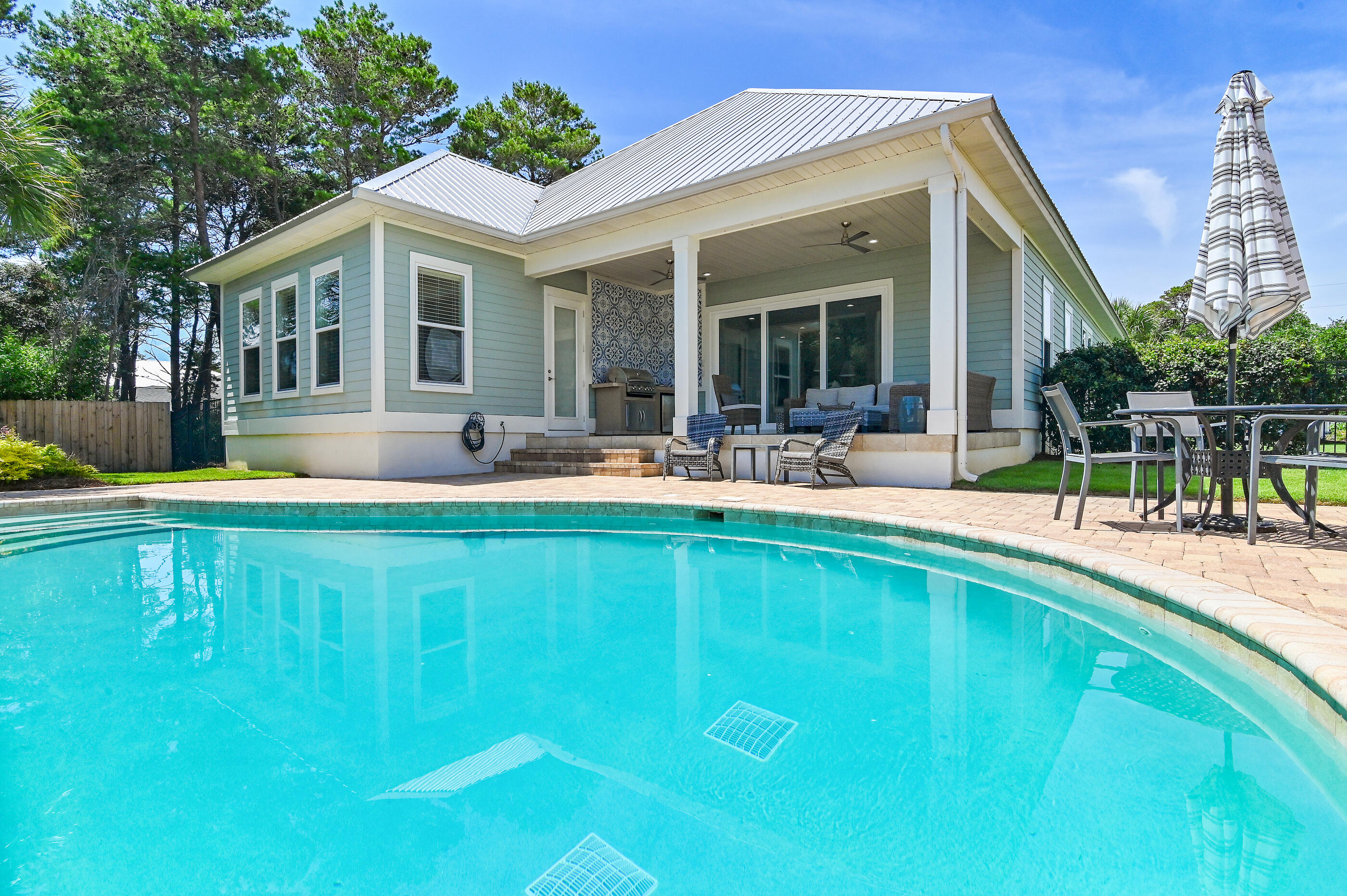 Welcome to Blue Heaven - Your Ultimate 30A Coastal Retreat!Experience the beauty and relaxation of beachfront living at Blue Heaven, a luxurious beach home just a five-minute drive from the stunning Gulfview Heights beach access and the vibrant boutiques and dining options of Blue Mountain Beach. This coastal gem combines stylish elegance with outdoor living, featuring expansive euro doors that open into a mesmerizing outdoor oasis.Step out into the oversized, fully fenced yard, where you'll find a sparkling pool perfect for lounging and frolicking under the sun. The outdoor kitchen and entertainment area invite you to host memorable gatherings, all surrounded by beautifully curated coastal furnishings and decor that showcase an elegant coastal palette. Inside, the open-concept living area welcomes you with high ceilings, abundant natural light, and sophisticated touches throughout. The chef's kitchen is a culinary dream, equipped with stainless steel appliances, a dynamic granite center island, and oversized pendant lighting that creates an impressive dining experience.
The home offers two luxurious master suites, each featuring a king bed, en-suite bathroom, and one with private access to the outdoor space, providing a spa-like escape after a day of fun. An additional bedroom is featured on the main level. All offering en suite and elegant bathrooms with porcelain tile.
The upstairs is its own sanctuary where adventure and fun are discovered in the bunk room featuring four full bunks with oversized beanbags and Media center.
Blue Heaven awaits - a stunning coastal retreat that promises relaxation, adventure, and memories for a lifetime!
Envision full-time living at the beach or a secondary vacation getaway. This could even be a perfect rental investment as it is currently on 30A Vacay's program all furnishings to convey with the property.