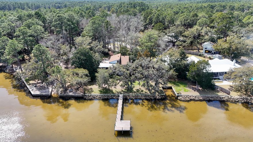 BAYFRONT 1.3 acre lot adjacent to Kellogg Park in beautiful South Walton.  198 feet of Bay frontage and extremely beautiful lot with ancient Live Oak trees situated on this high & dry property.  The house has not been occupied for several years and will require substantial renovation prior to occupancy,