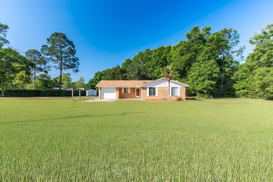 BRICK HOME ON 1.09 ACRES NOW AVAILABLE... and this one comes with 4 gifts with purchase and 1 BIG BONUS! BONUS--You can split the lot and sell the lot split for CASH! I have a builder ready to offer $40,000 for the split. Details in agent notes. GIFT WITH PURCHASE #1--The seller removed the carpeting in the living room, hallway and bedrooms. They are offering a $4000 flooring credit, so you can design your new home to suit your taste.  GIFT WITH PURCHASE #2--The seller will leave their lawnmower for the new owner, with acceptable offer.GIFT WITH PURCHASE #3 AND #4-- Details a little later!Now let's talk floorplan!This 3 BR/2 Bath brick ranch was a long-term family home, and sellers made significant improvements throughout the years. There's a NEWER ROOF with 2 NEW SKYLIGHTS.. WOOD-BURNING STONE FIREPLACE.. AND A NEW WATER HEATER!!! 

The living room is spacious with rich walnut trim and moldings, as well as paneled walls which offer the buyer untapped equity. The stone fireplace is the focal point and warms the space.

The kitchen is galley-style with oak cabinetry, faux butcher block counters, NEW SILESTONE SINK AND FIXTURES, pantry and large dining area. 

No paneling in the bedrooms! Each one features sheetrock with more rich walnut trim. The master bedroom boasts walk-in closet, and the master bath offers single vanity with cultured marble counter and coastal blue tub/shower combo. 

Bedrooms 2 and 3 feature spacious closets with wood shelving, and are almost identical in size and shape. 

The laundry area is in the garage (single car), and offers 2 more gifts with purchase-- WASHER AND DRYER!

Now's lets talk about my favorite spot in the home-- the back patio. This expansive 50 x 12 COVERED PATIO offers picturesque views of cypress trees and hardwoods. The backyard is large, flat and fenced along the back boundary line. 

The side yard is even more spacious, with the possibility of a lot split (BIG BONUS)! As previously mentioned, builder will pay for the split, or you can keep it for yourself or a family member. #OPPORTUNITYKNOCKS

This property was well-loved but sellers say their children and grandchildren have moved away, so it's time for a new family to make this property their own.

This one is priced to move. Better hurry!