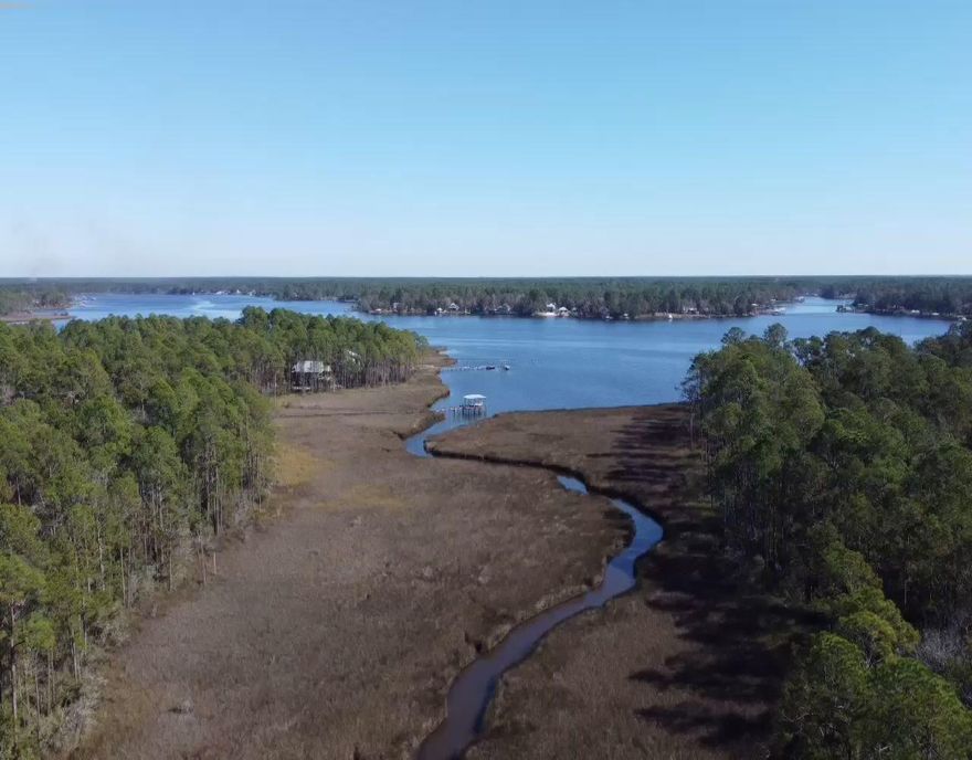 Sizable interior home site adjacent to creek front lot with 155' of navigable water front providing Bayou views. Both lots situated on low-traffic cul-de-sac. in Cross Creek Shores.  This prime Bayside Development consists of only 40 lots and is located along Bay Loop Road in Freeport-one of the fastest growing cities in NW Florida. Located just 12 miles from the beautiful Beaches of South Walton. The community of Hammock Bay with its new General Store is adjacent to Cross Creek Shores. The New Publix and several new restaurants  as well as other new shops make this a convenient location as well as a quiet paradise by the Bay. Adjacent water front lot 31 D also for sale-seller will not sell this interior site until 31 D sells.