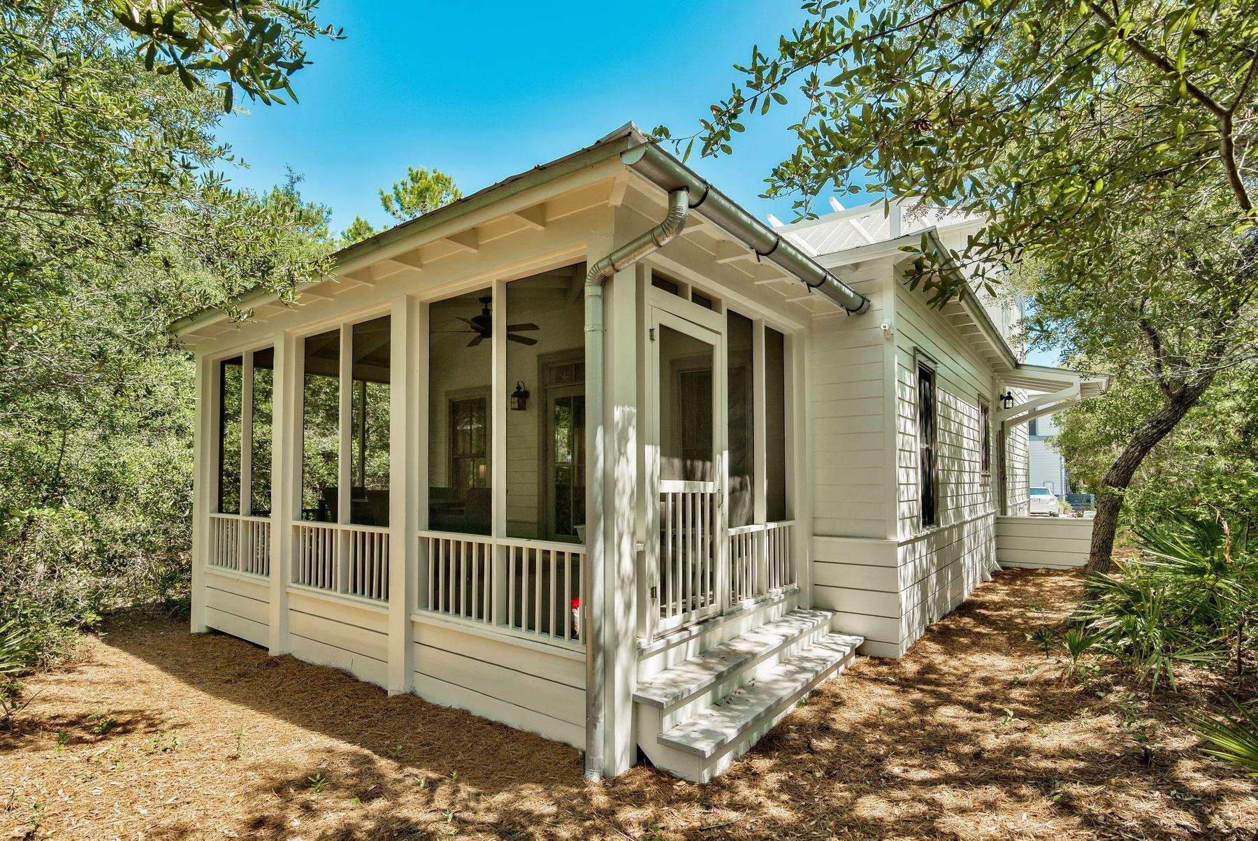 A stylishly renovated kitchen and all-new paint inside and out really make this three-bedroom, three-bath coastal cottage shine. Situated at the end of a quiet cul-de-sac in Magnolia Cottages by the Sea, it is close to Scenic Highway 30A amenities and just a five-minute walk from the beautiful beach in Seacrest. This tastefully renovated home is offered fully-furnished making it an attractive proposition for those looking for a second home or vacation rental property. Gleaming hardwood flooring creates a natural flow through the open-plan living area which includes a well-planned kitchen. Smart white cabinets with panel detailing and a full range of new stainless steel appliances create an upscale tone. The high-top breakfast bar is perfect for casual dining after a busy day of sunbathing and beach activities. Gather around the dining table for meals and entertaining then relax in the spacious sitting area and watch your favorite programs on the wall-mounted TV. There are two well-appointed bedrooms on the first floor including a built-in bunk room. Climb the stairs to the nicely proportioned master suite complete with private balcony and fetching wooded views. This is a home for embracing an outdoor lifestyle with a screened rear porch on the first floor and an upper level sun terrace with retractable awning and treetop vistas. You hardly need to leave the neighborhood as it has its own community pool and beach access for morning walks and swimming on the glittering white sandy beach. Neighboring Alys Beach and Rosemary Beach communities boast a wide choice of dining options, boutique shopping and live entertainment. Camp Creek Golf Course and Deer Lake State Park provide further recreational activities including hiking, birding, kayaking and water sports in an eco-friendly environment.