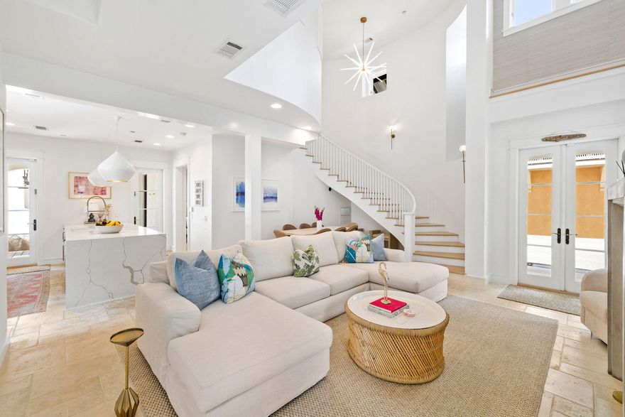 This generous corner lot in the renowned community of Rosemary Beach boasts a main house, carriage house, 2-car garage, pool and a spacious courtyard with outdoor fireplace. The home borders West Kingston Park, a lush picturesque area to enjoy relaxed summer evenings. Step into the soaring living room filled with natural light anchored by a contemporary fireplace. Living opens to the dining area and the updated gourmet kitchen with waterfall Cambria quartz counters, Sub Zero and Wolf appliances, and professionally designed pantry. A spacious bedroom with en suite bath on the main level opens to the covered porch and show-stopping courtyard. Distinctive designer lighting, grasscloth wallpaper and new furniture are a few highlights of the home's fresh interiors.