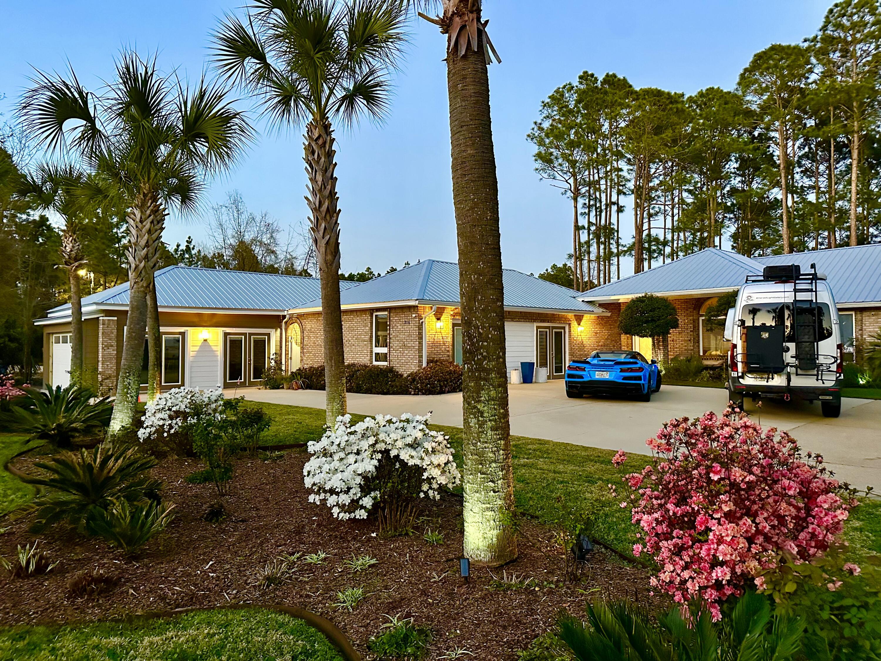 Rare Opportunity to own a unique property situated on lake Alicia in Santa Rosa Beach Florida! Great location 2 miles from the Gulf beach access and 2 miles from bay boat access. This is Essentially two homes on an approximately 3/4 acre lot. One carriage house consisting of 2 apartments- A one bedroom apartment (1 bedroom 1 bathroom) with private entrance and a studio apartment, also a 1 bedroom one bathroom with a two car garage with skylights and private entrance. The main residence, 3 bedrooms 2 bathrooms also has private entrance and plenty of parking, tons of natural light, east/west oriented with lake views throughout. Large outdoor covered porch complete with hot tub. All three separate living areas have been completely renovated, 3 kitchens and 3 laundry areas. More photos coming soon!
All on one level, no HOA, and not in a floodplain(zone x). The lot is something to see to appreciate. Beautifully landscaped with mature trees, gardens well groomed and irrigated. There is even a small pond with a fountain. A dock nestled along lake Alicia, complete with a powered shed and 4 vegetable gardens. Relax in the Hot tub on the 420 Sq.ft covered screened in patio, included in the sale. The newly built 2 car garage is equipped for an electric vehicle. All units have their own private fenced in area. New floors, new paint, new solid quartz countertops and backsplash, new toilets, custom built on site cabinets. This property has it all!