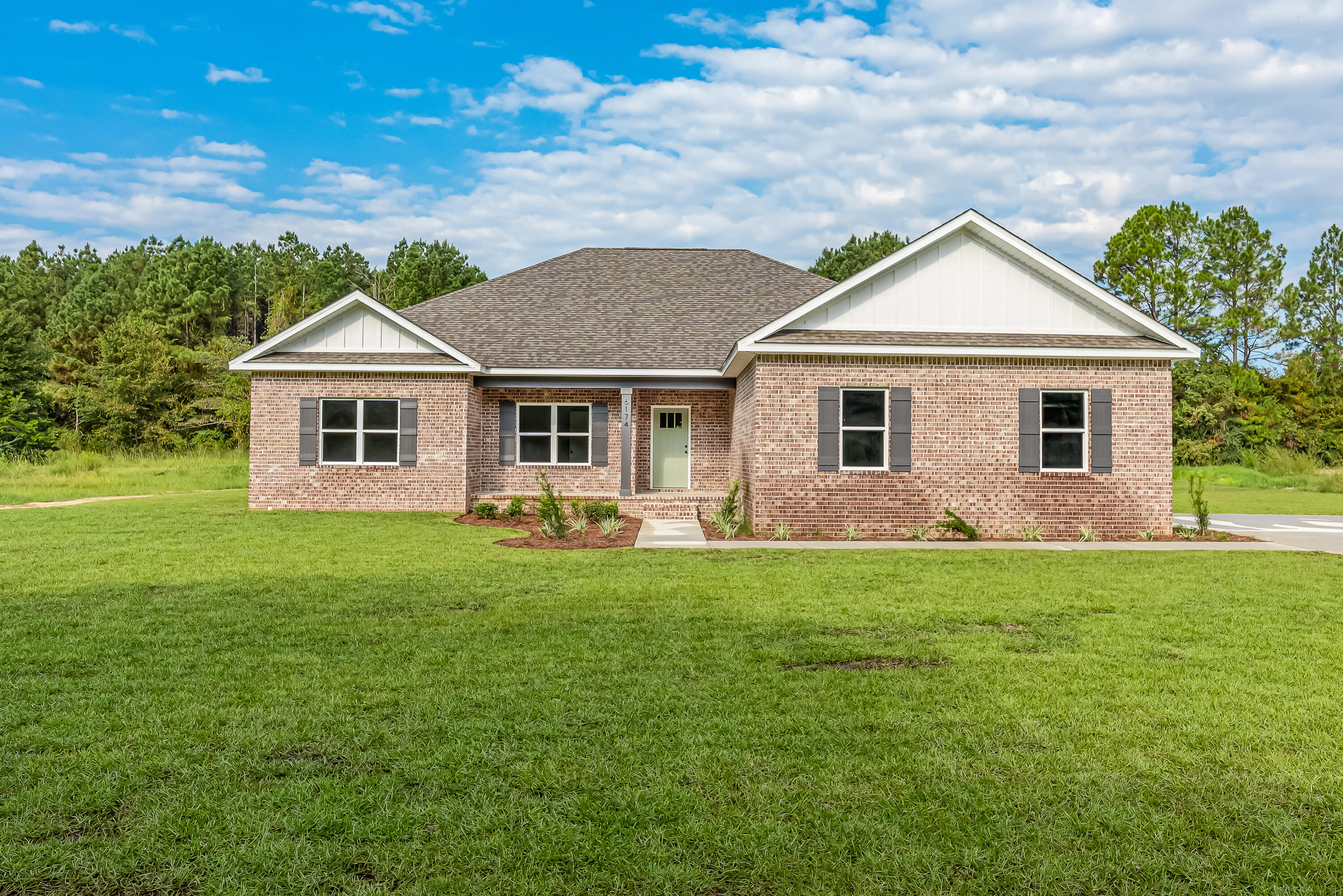 1.74 acre lot and a brand new home! Love the color combination at this beauty! Custom cabinetry, wood look tile throughout. Quartz countertops. This is a 4 bedroom, 2 bath home PLUS office that could easily be used as a guest bedroom or craft room. Stacked stone electric fireplace is a statement piece in the living room as well as a custom barn door to the office! Lot is only partially cleared and goes several hundred feet back into the wooded area. Massive covered back porch has stained wood ceiling. One year builder warranty included!