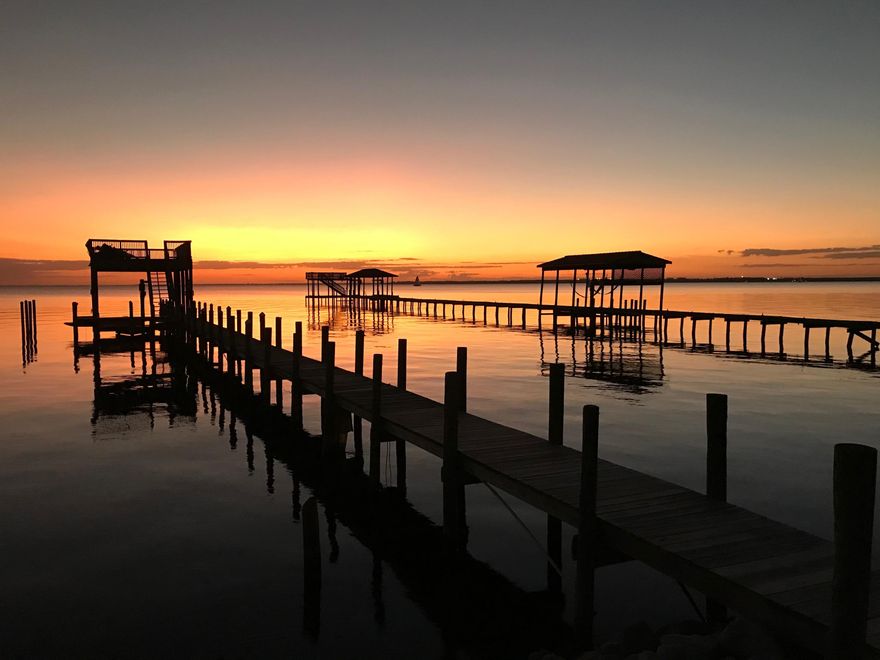 HUGE PRICE REDUCTION !!! TAKE A LOOK AT THE LAST WATERFRONT LOT AVAILABLE IN SUNSET BEACH PRIVATE COMMUNITY.LOT ALREADY HAS A DOCK WITH A COVERED BOAT SLIP AND RAISED SUNDECK FOR ENTERTAINING AND THE MOST SPECTACULAR SUNSET VIEWS. SUNSET BEACH IS ONE OF 2 GATED NEIGHBORHOOD'S ON THE WATER IN BLUEWATER BAY. PRIVATE CLUB HOUSE AND POOL IS ALL PART OF THE HOMEOWNERS ASSOCIATION.