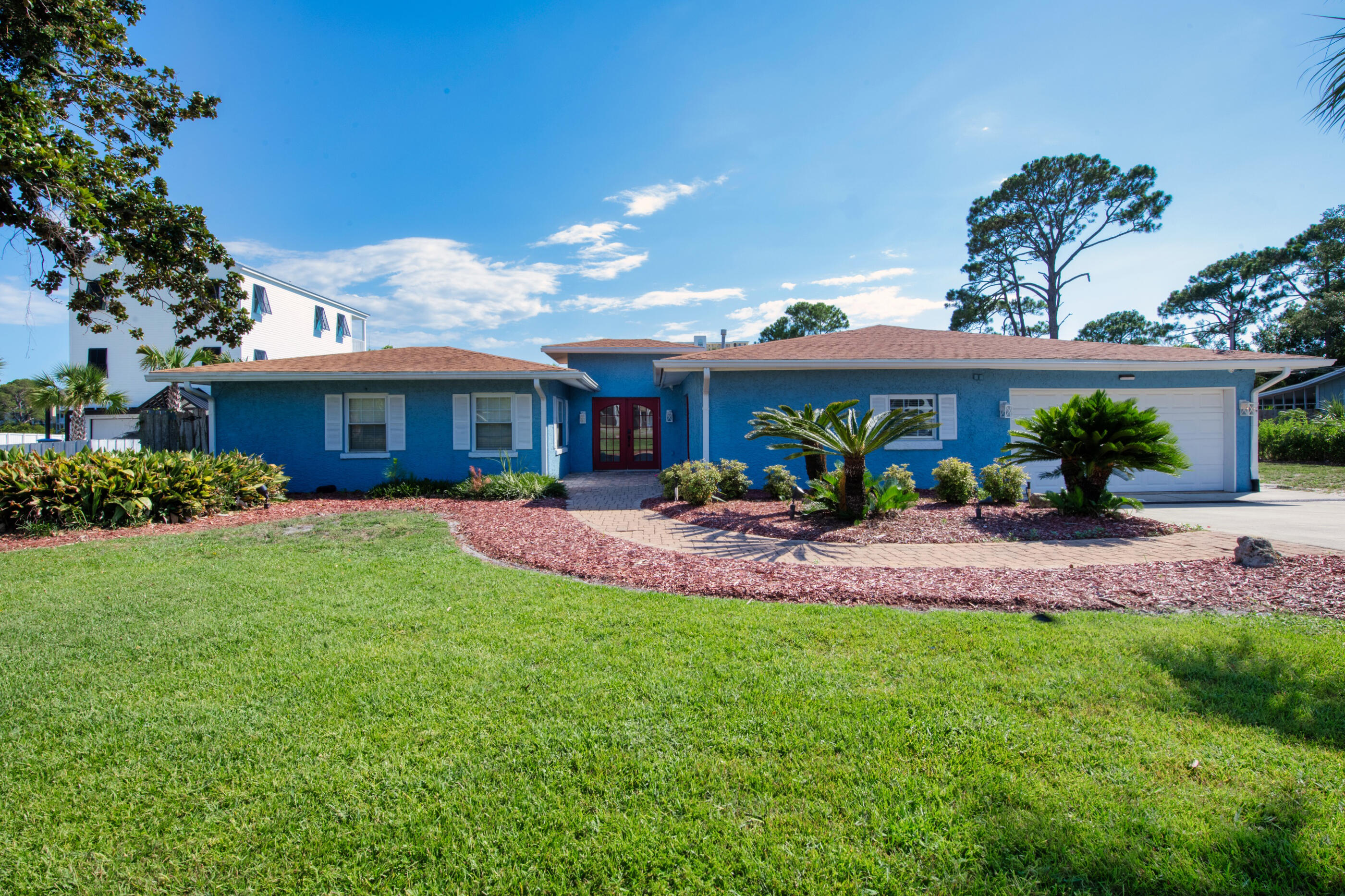 Welcome to your dream waterfront oasis on North Lagoon in Panama City Beach! This beautifully updated, one-story home is a successful short term rental, fully booked on Airbnb through April, and sold fully furnished! Offering 100 feet of stunning waterfront views, this property includes modern upgrades such as fresh paint, new ceilings, new HVAC, fans, and outdoor lighting. The roof was replaced in 2016. Inside, you'll discover 4 spacious bedrooms and 3 luxurious full baths. The gorgeous kitchen features granite countertops and stainless steel appliances, flowing effortlessly into the bright Florida room. The master suite, with hardwood floors and a private deck, provides a serene retreat. Step outside to your private backyard resort, complete with a pool, patio, green space, and your own PRIVATE DOCK for your boat in the lagoon. Additional highlights include a spacious living room with a gas fireplace, a private office with its own entrance from outside, and a 2-car garage. With NO HOA and situated on over a 1/2 acre lot, this property offers both privacy and convenience. Don't miss your chance to own this fully-furnished, fully-booked waterfront gem!