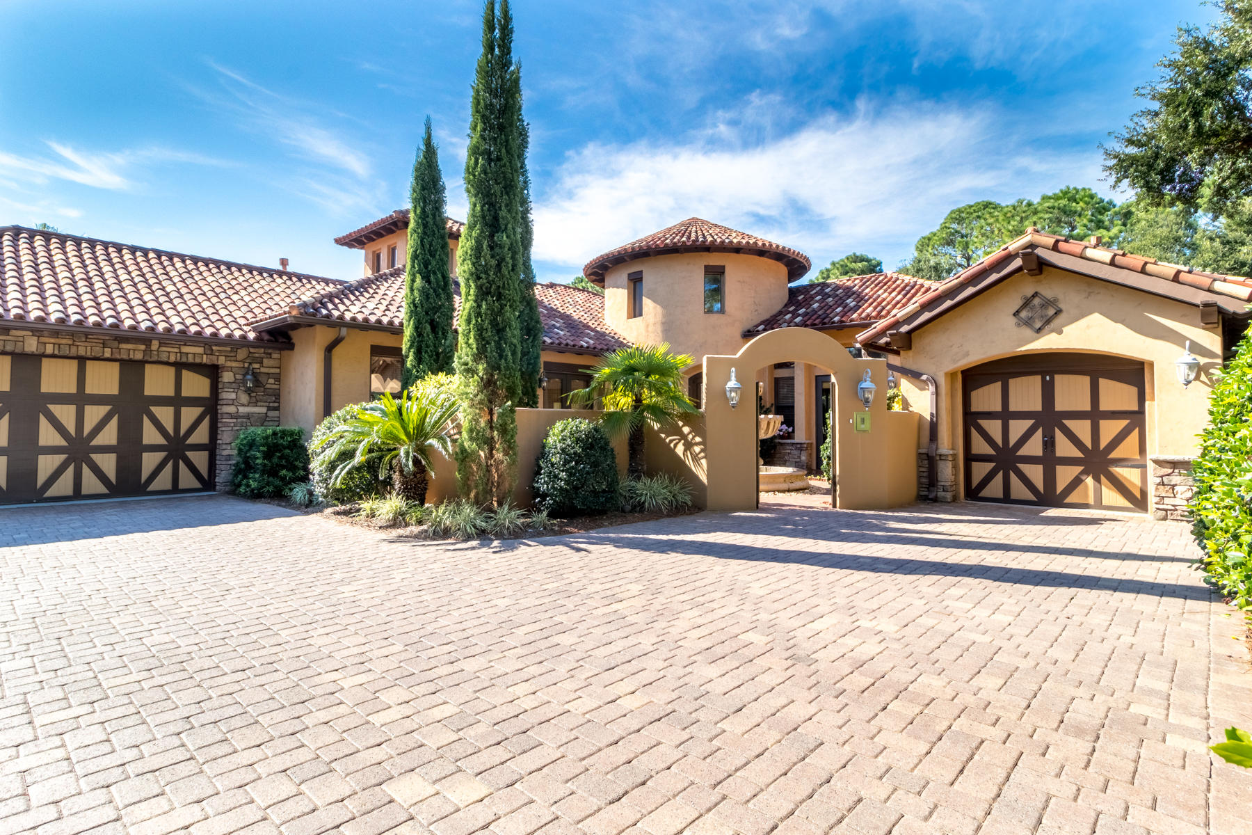 Welcome home to your Tuscan oasis - being offered fully furnished and turn-key. Located on a cul-de-sac with serene views over the 2nd tee box of the Burnt Pine Golf Course. As you enter through the gated courtyard with a tranquil fountain, you are welcomed with an arched mahogany door leading to a grand circular foyer. Well-appointed architecture will catch your eye from the moment you walk in! Featuring wood-barrel ceilings, curved walls, a beautiful blend of travertine & distressed hardwood floors, 3 gas fireplaces, and a screened lanai equipped with a heated pool and hot tub with waterfall, summer kitchen, and multiple lounging areas. At the heart of the home lies the gourmet kitchen featuring a large island, 5-burner gas stove, double oven, and an oversized GE Monogram fridge.
