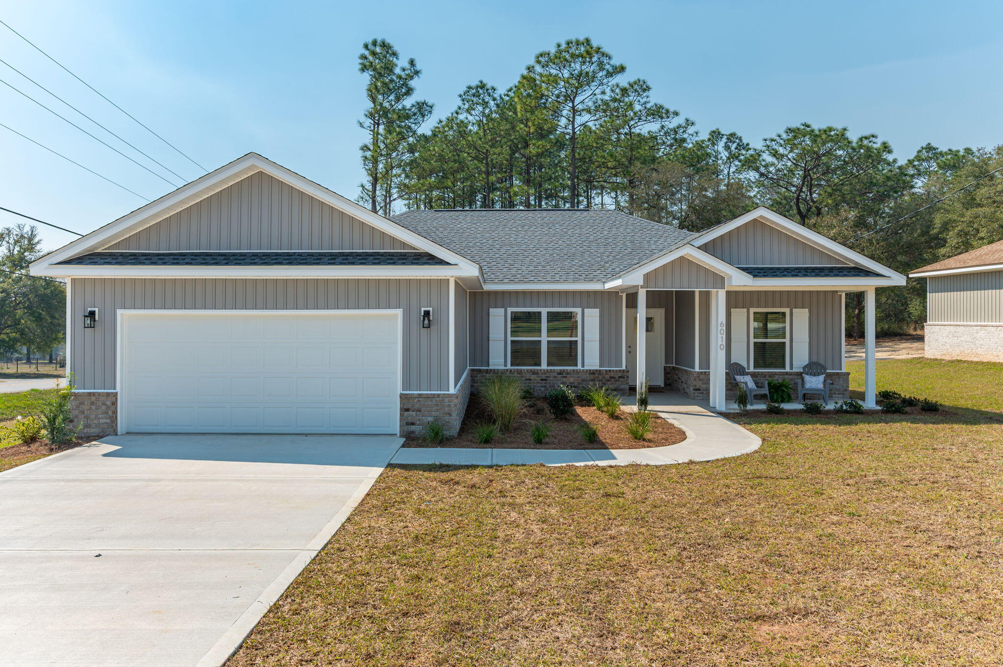 Welcome to this quality built 4-bedroom, 2-bathroom customized home, showcasing an open floor plan and a functional use of space. The builder is offering a $10,000 contribution toward BUYER'S CLOSING COST w/ the use of builder's preferred lender, and as an added bonus, has installed blinds throughout the home and a side-by-side refrigerator. The common area features cathedral ceilings, creating a sense of openness. The kitchen boasts rich blue cabinets, providing a striking contrast to the walls and quartz countertops. The kitchen is fully equipped with appliances, including refrigerator, and features an oversized island with farm sink. The master suite is complete with a treyed ceiling and bathroom, featuring a dual vanity, soaking tub with separate shower, and walk-in closet. Split bedroom design offers added flexibility. The rear guest bedroom features a French door leading out to the 27' x 8' patio as does the living room, perfect for outdoor entertaining. Even better - there are no HOA fees!! Both the residence and location offer a unique combination of style, convenience, and affordability. Room dimensions and lot size listed here are approximate. Buyer to verify all areas of importance!

Builder to provide a 1 year warranty and soil treatment upon closing! 
