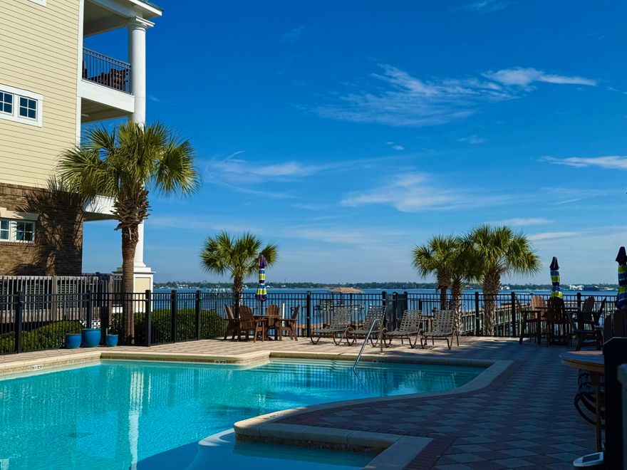 Experience the ultimate in luxury living at Waterhaven, Panama City Beach's premier gated community. Nestled on the east end, this stunning development is within close proximity to top-rated restaurants, Marinas, and the magnificent St. Andrews State Park. Residents are just a short 5-minute drive from the area's most beautiful beaches. This impeccable condominium boasts an unbeatable location, merely 100 steps from the breathtaking Bayfront pool, dock, and famous St. Andrews Bay, where residents can indulge in various water activities. A convenient storage unit is also provided on the upper floor of the building, ideal for storing beach essentials and personal items. Plus, there are two parking spots allotted for this condo as well. As you enter this bright and airy condominium, you will be struck by the abundance of natural light and meticulous attention to detail, including the well-maintained hardwood flooring, trayed and nearly 10-foot ceilings and the crown molding. The upscale kitchen features high-end appliances, such as a Sub-Zero refrigerator, Viking 6 burner stove, Bosch dishwasher, Scotsman stand-alone ice maker, and Sub-Zero wine chiller, as well as a stunning, expansive center island. This spacious, open concept living area is perfect for entertaining friends and family. French doors lead to the Bayside balcony from the living room, and the master bedroom has balcony access as well, for more living space. There is a spacious master bedroom with a master bathroom that has a double vanity, large soaker tub and a walk-in closet. The other two guest bedrooms are spacious and share a full Jack n Jill Bathroom. Live in luxury, surrounded by breathtaking views, and enjoy relaxation time lounging by the pool or taking a leisurely walk along one of the area's largest private piers, where there is boat slip availability. Waterhaven provides a welcoming neighborhood atmosphere, complete with community events and social clubs. The Waterhaven Clubhouse boasts an impressive array of amenities, including a movie theater, meeting room, kitchen and fitness center. Additional amenities include a private beach, boat launch, pool, and grill/smoker. Waterhaven's community amenities further elevate the living experience, offering access to a boat ramp and day dock for limitless waterfront enjoyment opportunities. Residents can enjoy peace of mind, knowing their belongings are secure, thanks to gated security and fenced boat storage. This condo embodies the perfect fusion of luxury, convenience and community living. Note: This condo will have all assessments paid and all repairs to this building have been completed. The condo is being sold with the furniture and TVS but the furnishings, such as, linens, pictures, accents and personal items will not convey. The Seller is offering a Home Warranty to Buyer of $500 at Closing. 