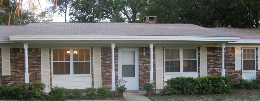 This beautiful brick home has been well maintained. Interior has been freshly painted and home is move-in ready. Well organized floor plan features living/dining area with custom built bookcase and additional spacious family room with fireplace and brick accent wall. Family room is adjacent to the kitchen with refaced cabinets, new hardware, new counter tops, new sink and appliances. Covered porch overlooks the back yard with play area and storage shed. Very spacious laundry room with cabinets and shelving for storage. New flooring throughout the house. Still under warranty are: New windows with hurricane covers, 2011; New central air/heating system, May 2013; New roof repairs,2014. Driveway was redone in 2011. Garage has custom made storage and work area, bike racks