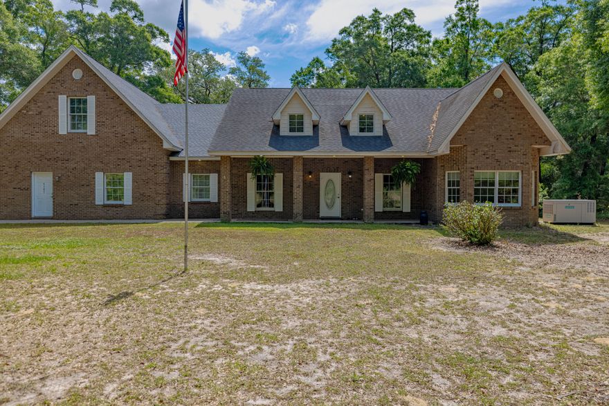 : Located just 40 minutes N of PCB and nestled between Holmes Creek and the Choctawhatchee River, this brick home combines the serenity of country living with all the luxuries of modern amenities. You can launch your boat at the nearby public boat launch for great fishing or swimming in the nearby springs. 4 spacious bedrooms and 3.5 bathrooms, this home is designed for comfort and convenience. The large kitchen features a double oven and an oversized refrigerator.  The open-concept layout allows the stone fireplace to become the focal point of the main living area. The master suite and two bedrooms are conveniently located on the main floor. Upstairs is finished above garage.  Step outside on screened porch - complete with sink and fans. Full Generator for assurance of never losing power