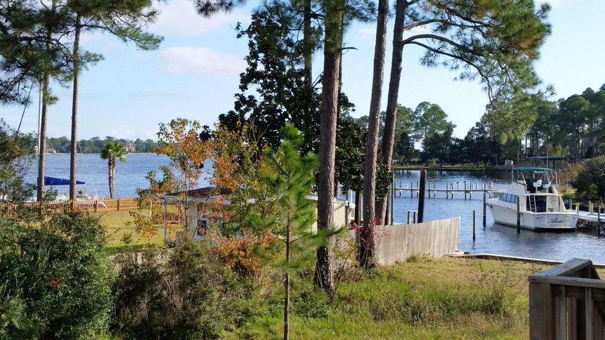 Awesome sunrise & sunset views of the Bay! This custom home packs a lot on the main floor plus an ADDITIONAL 17x23 sqft BONUS/Media ROOM downstairs with bar and 1/2 bath not included in square footage. The kitchen features new stainless appliances w/refrigerator and features custom cabinets w/oversized center island and granite counters. The master bedroom features treyed ceiling w/hidden dimmer controlled lighting. The master bath features custom tiled shower shower and tiled Jacuzzi tub beneath window for added lighting.Walk out through French doors to the next Custom feature on our tour from the living room or master bedroom to the huge deck where you will spend hours with awesome views of the bay! (porch swing not included) Extra wide stairs lead you down to the custom deck...