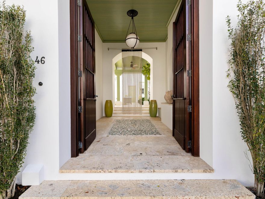 Enviably located in the heart of Alys Beach, this architectural masterpiece combines elegant sophistication with peace and privacy. Designed by architect Steve Mouzon, it has a central courtyard around which all the other rooms are arranged. It creates an exceptional private sanctuary for the ultimate indoor-outdoor lifestyle. A glass door opens into the eat-in kitchen and spacious open floor plan with cool Dominican stone flooring creating a neutral base. Culinary enthusiasts will appreciate the gourmet kitchen with high-end Thermador appliances and custom cabinets featuring extraordinary red gum hardwood. One area houses a dedicated coffee station. An expansive island has limestone counters and three stools for cocktails or snacks. The formal dining table easily seats six beneath a vaulted 12-foot ceiling supporting a sparkling chandelier. After dinner, relax in the spacious sitting room, where chairs are grouped for conversation around the fireplace. Multiple windows introduce natural daylight and views of the quiet street outside. Head upstairs to find a landing with an office or reading nook overlooking courtyard views. Two beautiful guest suites have polished pecky cypress flooring, ample closets/dressing rooms, and luxury private bathrooms, each with an earthen stone vanity. The master suite is in an entirely separate wing with its own private access from the courtyard. Beautifully architected, it displays elegant arches, mosaic tile wall features and a two-way gas fireplace warming both the bedroom and bathroom. Stone tiles, pebble insets and twin vanities with vessel sinks reinforce a sense of nature. Lie back in the stunning garden tub and enjoy moments of bubbly bliss in this spa-like haven. French doors open into the courtyard, where a tinkling water spout creates a pleasing backdrop. The outdoor shower is the perfect place to rinse sandy feet after a swim or stroll on the nearby beach. An outdoor kitchen provides everything you need for alfresco dining and lounging on cushioned seats in sunshine or shade. The home has new A/C, fresh exterior paintwork, custom lighting, new furnishings and off-street parking for two vehicles. Beyond this private enclave, a host of activities beckon, including the owners' private beach club and the serene Caliza pool for swimming, lounging and dining. Zuma Wellness Center is fully equipped for a workout and massage. Multiple parks and green spaces provide pleasing areas to ramble or you can hop on your bike and explore the restaurants, shopping and entertainment on offer along Scenic Highway 30A.
