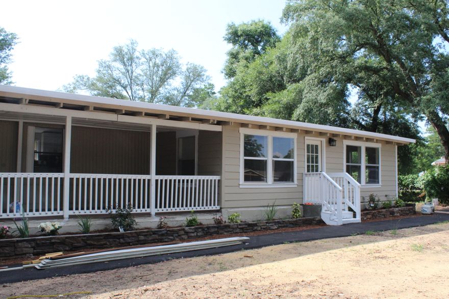 Price Improvement! Welcome home to this freshly updated 3 bedroom in Mossy Head. This serene neighborhood has mature trees and the relaxing feel of country living, but you're just a couple miles from the I-10 access and only 13 miles to DeFuniak Springs/about 15 miles to Crestview.  They say the heart of a home is the kitchen, and WOW--new white-Shaker cabinets topped with sparkling granite counters, and finished with new stainless appliances. The kitchen offers a pantry and breakfast bar, which opens to the living room with a view of the back deck through the slider. The entire home has beautiful wood-look LVP that runs throughout AND every room has been freshly painted.  Both bathrooms have new vanities and custom tiled showers! The main bedroom has a walk-in closet with custom shelves.