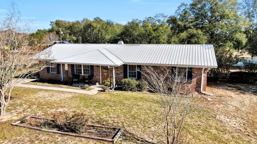 Come see this delightful, nicely updated brick pool home, just across the street from Lake Stanley. The front porch invites you into your open and airy living room with gas fireplace and real hardwood floors. This opens into your dining area and kitchen with new countertops & primed shaker cabinets doors, ready for you to choose your own color! Freshly painted home & updated for a move-in ready space. Large utility room with room for freezer, extra storage, etc., and opens up to your back patio and in ground pool! Separate side yard with plenty of room for other activities besides swimming or lounging. Long lasting metal roof also. Qualifies for all types of financing and surely won't be on the market long, so don't wait to come see!