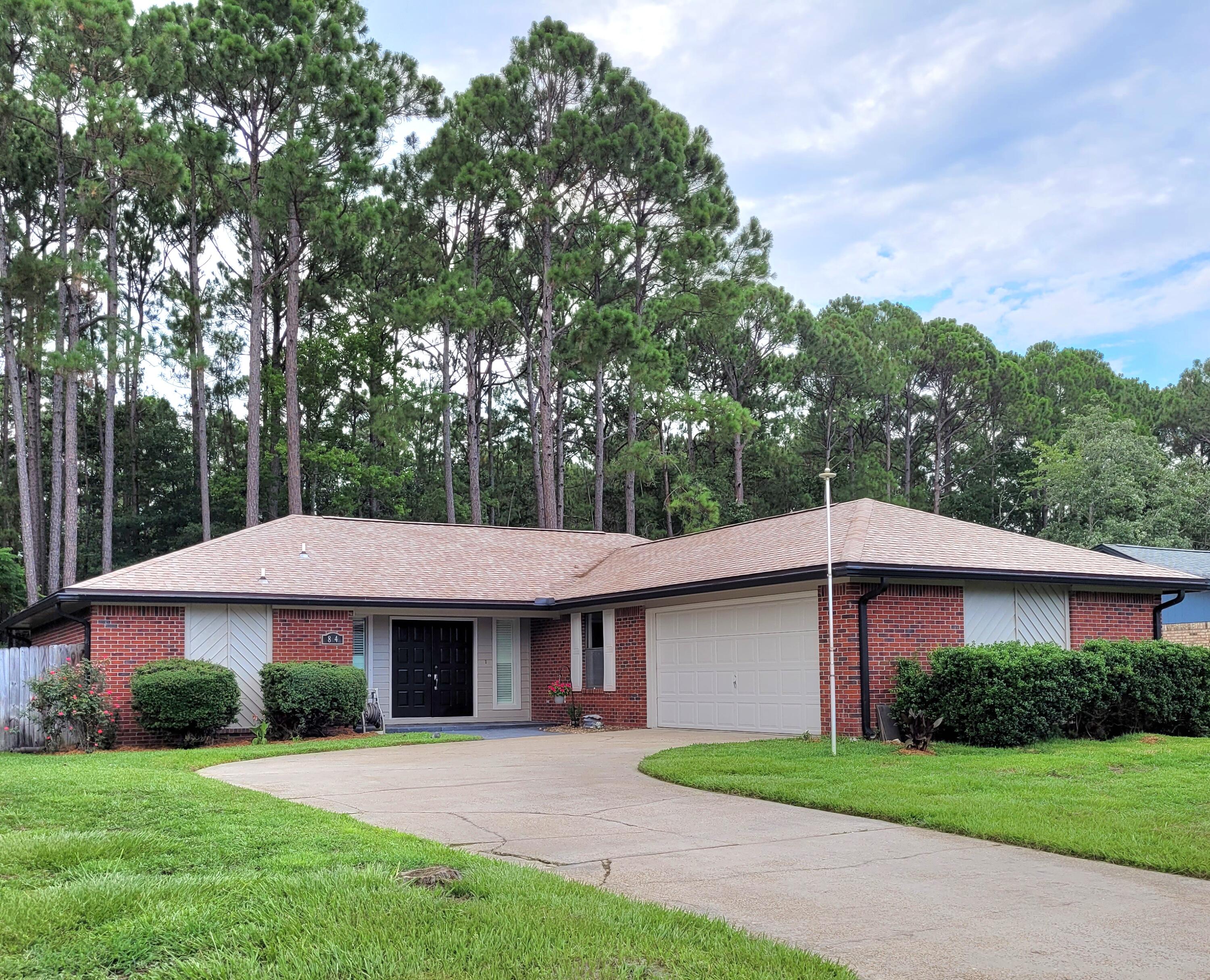 Great home in very desirable location convenient to Hurlburt Field and Eglin Air Force Base. Huge yard backs to the Eglin Reservation for ultimate privacy. Enjoy grilling and entertaining on the large rear deck. Double door entry leads to large living room featuring a vaulted ceiling and fireplace. Good cabinet and counter space in the kitchen with a walk-in pantry and wet bar. Beautiful hardwood flooring in kitchen, dining room, foyer and bedrooms with travertine in the living room and sun room. Large master bedroom offers bath with dual sinks and marble jetted tub. Inside laundry room with cabinets for extra storage. Hot water heater was installed in 2022, HVAC in 2011 and roof in 2019. The home is wired for a generator which is included for peace of mind. Ready for occupancy!