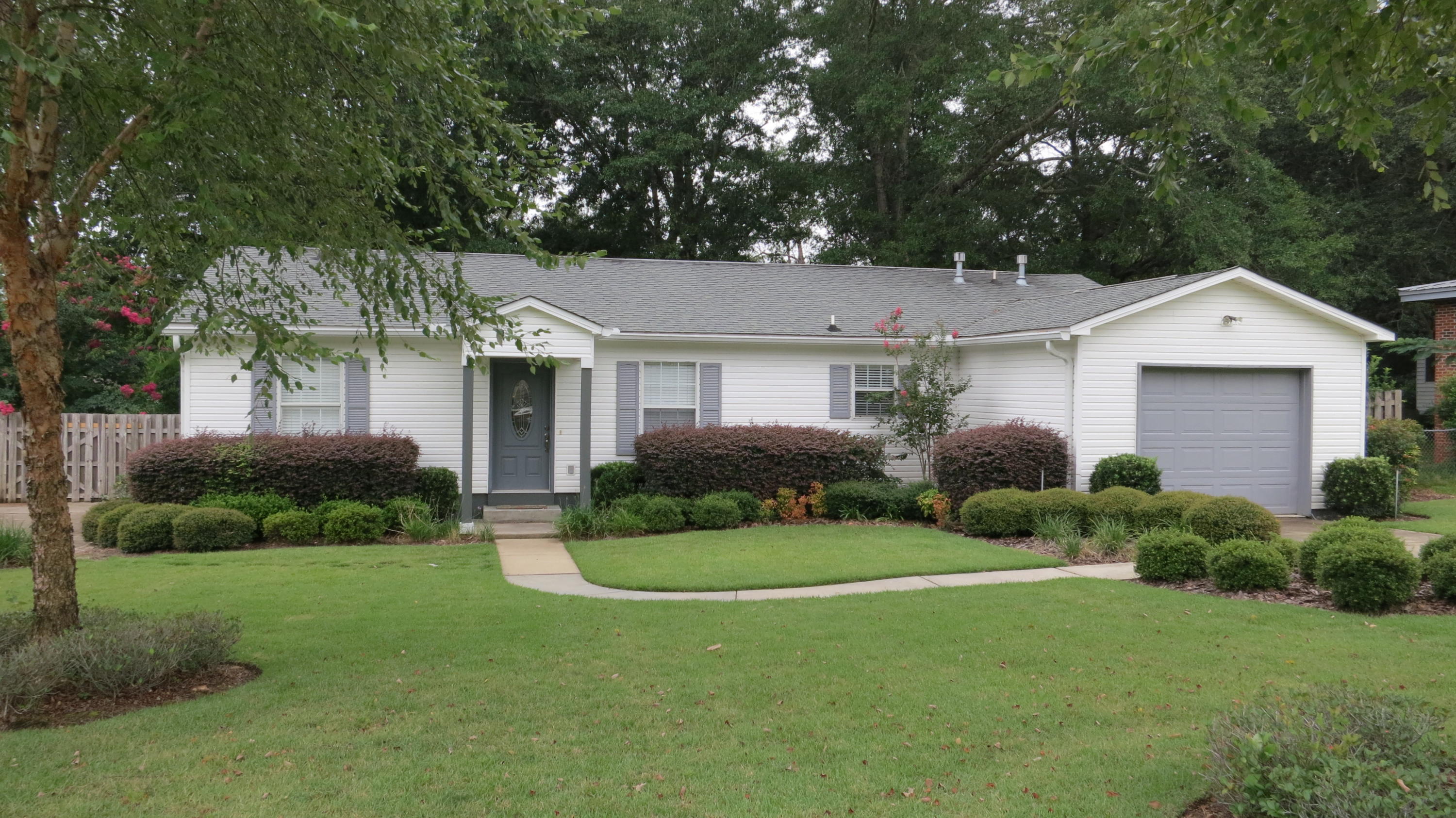 Charming and newer home built in 2005 conveniently located near Eglin AFB! This all vinyl, low maintenance home sits on a fabulous lot with large shade trees, and extra parking through a double wide gate in back for a boat, an RV, or any other ''grown up'' toys you may have. The large back-yard deck hosts a wonderful outdoor kitchen complete with built-in grill, sink and small refrigerator. Inside you will find an immaculate home with tile floors in living areas, kitchen & baths. The kitchen is open and spacious with a bar, stained wood cabinets and stainless appliances, and is open to the generous dining area, which opens to the nice family room. You have plenty of room for furniture and entertaining here! The split bedroom plan offers privacy with the master on the opposite side of the guest rooms. The master bedroom hosts a large walk-in closet, and nice master bathroom. The guest rooms share a hall bath and each have large wall closets. The laundry room is just off of the kitchen. This home is move-in ready! Kids will love to play in the large back yard, completely fenced in and backs up to woods of Eglin. There is a sprinkler system on a well to keep that yard beautiful all year. Sellers are offering a 1 year home warranty. This newer home in convenient Valparaiso will not be on the market long, so make your appointment to see it today! Buyer to verify all measurements important to them.