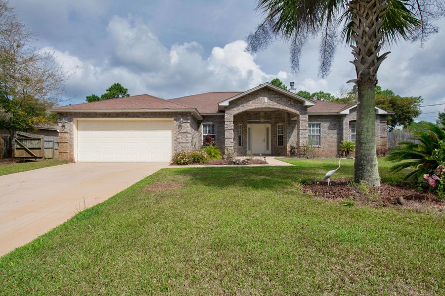 Welcome home! The seller is offering a $5,000 upgrade allowance to the home with an acceptable offer! New to the Navarre marketplace is this beautifully landscaped and manicured 4 bedroom home in the coveted HBTS subdivision. Located on a quaint street across from protected woodlands for privacy, you'll love the improvements the seller has performed. As you approach the home you're greeted by a massive front brick awning and light fixture. As you enter the home, you'll love the vast family room with wood burning fireplace. The kitchen is fitted with stainless appliances, updated lighting, and custom cabinetry. The mater suite features a make up vanity, with a jetted garden tub. In the backyard, you'll love the freshly tiled back patio with brick paver fire pit.