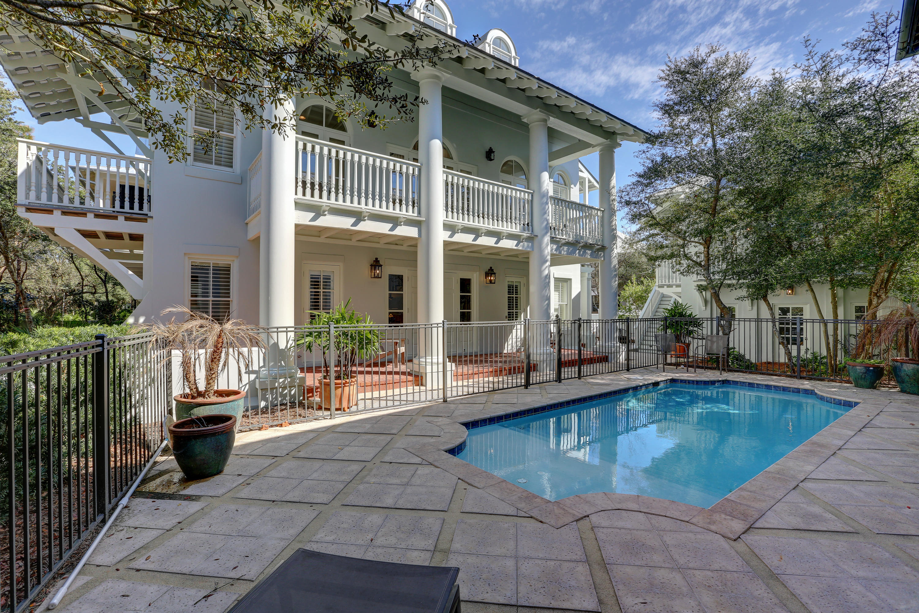 Major price drop! All new living room and kitchen furnishings added in April 2019, new 3rd floor furnishing in Sept 2019. Privacy abounds in this 3 story, all stucco home & carriage house south of 30-A, in Rosemary Beach. A large, heated pool along with separate patio with fire pit and grill, provide plenty of space for outdoor enjoyment. Entering through the front, bricked & columned porch is reminiscent of New Orleans grand plantation homes. The first floor houses the large, master suite complete with recently renovated bathroom. Bunk room with 4 beds, plus another bath and laundry room, complete the first floor. Ascend the curved grand staircase to the second level living area - kitchen, dining and living. Evenings will be spent dining al fresco on the spacious second level balcony!