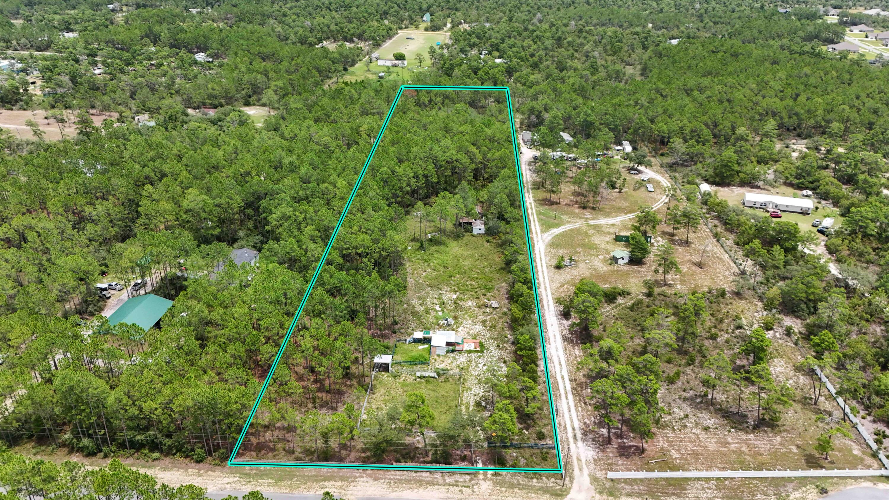 Prime opportunity to own nearly 5 acres in the growing community of Freeport. This expansive property offers the tranquility of country living, and ideal for those envisioning a dream home with ample space to roam, this stunning parcel awaits you! The partially cleared land offers two horse corrals, a large, covered deck, and 2 small sheds. Situated in an X flood zone, it presents limitless possibilities without the need for flood insurance. Plus, it's conveniently located near some of the world's most exquisite beaches, ensuring both privacy and proximity to coastal beauty. No HOA!!