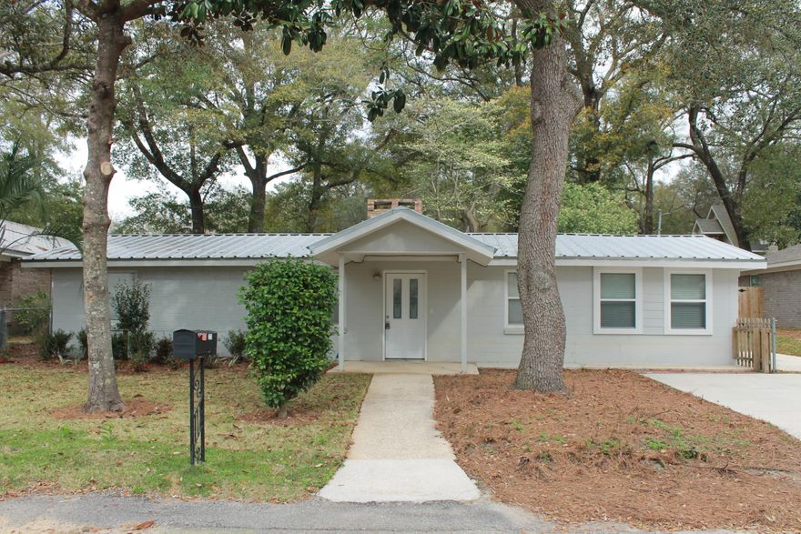 Welcome home!  Fantastic 2 bed/ 2 bath plus bonus den/office split floorplan home, featuring gorgeous wood look tile flooring throughout, granite countertops, and tastefully updated bathrooms.  This home has zero carpet which makes for easy cleaning and the perfect choice for those with allergies. This cozy home comes complete with a gorgeous brick wood burning fireplace.  Perfect location in the heart of Niceville with easy access to schools, shopping, and just minutes from NWFL State College, Eglin AFB.  Full remodel in 2015 including new metal roof, rewire, pex plumbing and gas tankless water heater, new HVAC system and duct work, new sheetrock, flooring and insulation.  Landscaping with sprinkler system just completed with Zoysia sod and fenced back yard.  Call to see this home today.