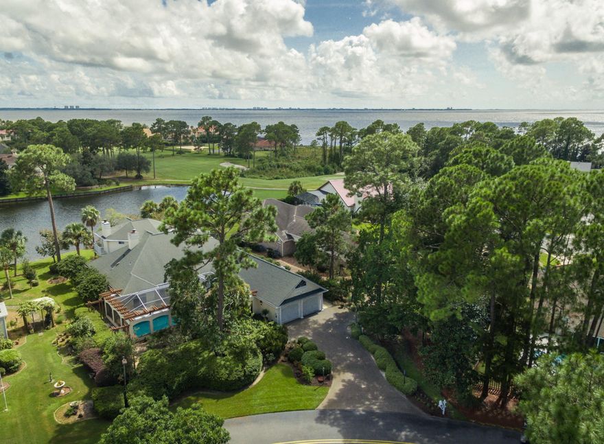 A European inspired lake front villa located in a gated community within Bluewater Bay Resort. Completely remodeled adding up to 2,800 sqft which was completed in 2007. This beautiful residence is professionally designed, feels like a new home and offers lake, golf course and bay views from nearly every window. Lush landscaping welcomes you to enter through a french garden gate into a private courtyard with heated saltwater pool, spa, fountain and LED lighting. Open the custom mahogany doors into this luxuriously appointed 5 bedroom, 4 bath open floor plan home. Travertine and Brazilian cherry floors, granite and marble counter tops, high ceilings, wood beams built-ins and a whole house water purification system.