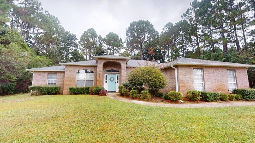 Situated in a well-established community just minutes from Navarre Beach, this spacious four-bedroom, two-bathroom home offers over 2,000 square feet of thoughtfully designed living space. Featuring a formal dining room, a breakfast room, with a layout that accommodates a variety of lifestyles. A great room anchored that invites gatherings anytime of year! Whether you enjoy morning coffee overlooking your wooded lot or quiet evenings on the patio, this yard is a blank canvas waiting for YOU to complete. The primary bedroom is a true retreat featuring closets, double sink vanity, a walk-in shower, and a separate soaking tub. Positioned on a generous lot, this home boasts a two-car attached garage with  room to extend driveway and access to a community pool, pickleball courts  and a multi-million dollar fitness center. For added convenience, essentials like a neighborhood supermarket are just a short drive away. Nearby parks, including Holley Ball Park with a playground, NYSA, and the YMCA, provide entertainment that everyone can enjoy. Quality craftsmanship and a convenient location near the white sandy beaches of Navarre make this home a compelling choice. 

