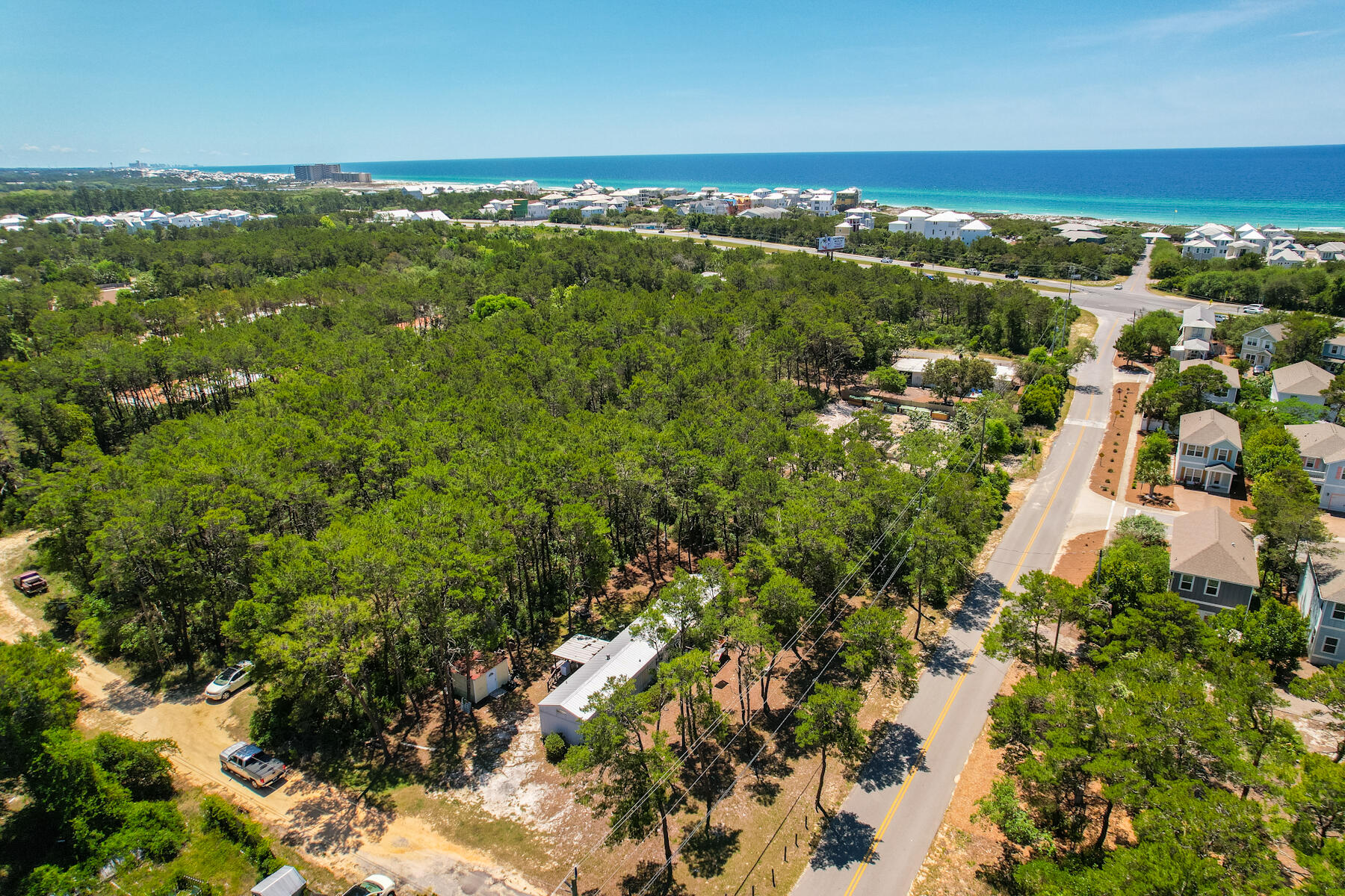 Nearly .3 acre corner lot in Inlet Beach just blocks away from Walton County's most exclusive neighborhoods and the Gulf of Mexico! The property is directly north of one of Walton County's nicest public beach accesses with restrooms and plenty of parking, check out the drone flyover footage to see for yourself! In addition, the new walking trail underpass from 30Avenue to Rosemary Beach will be a short stroll away. The property currently has a 3 bed, 2bath manufactured home with a nicely maintained, adorable interior and two porches. There are several great options for this property. First, you could use the existing home and have more space and fewer restrictions for storing your boat or vehicles than you could ever hope to have in one of the nearby HOA neighborhoods. Second, you could build your dream home on this spacious lot and never have to worry about HOA fees and hassles. Or, third, for investors, the Walton County Land Development Codes suggest that staff may approve a simple lot split of this parcel turning it in to two lots. With multiple options for future use, this property will not last long! Call your favorite Realtor for a showing. All facts are deemed reliable, but should be verified by purchaser.