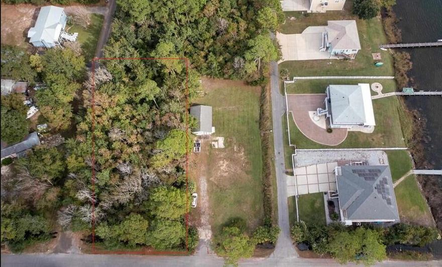 Waterfront views without the waterfront price!  .459 acre corner lot.  Steps from the boat ramp, Approx. 2 minutes from I-10. Septic needed. Zoning R1M. see docs for zoning and setbacks