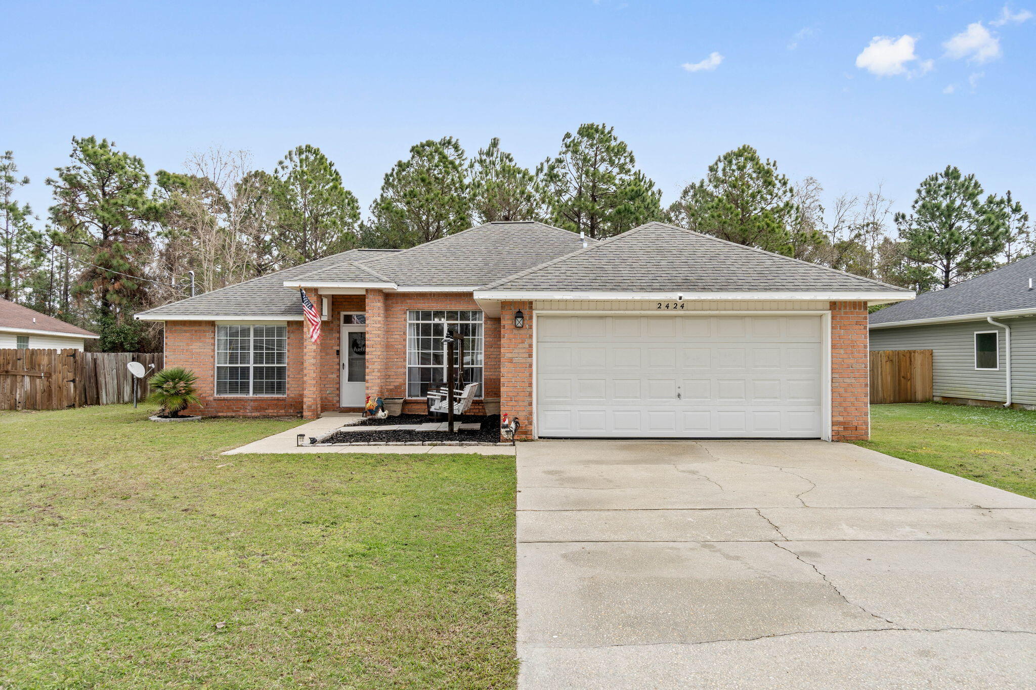 Welcome home to this lovely east Navarre retreat situated on a cul-de-sac street on over a quarter acre lot. Featuring 3 bedrooms and 2 bathrooms you're going to adore this tastefully updated and move-in ready home perfectly located to schools, sports, complexes, Navarre Beach, restaurants, and a short commute to Hurlburt Field! Pull into the driveway and appreciate the brick entry and tasteful landscaping, and enter insight to appreciate the newly installed luxury vinyl plank flooring that extends throughout the entire house (no carpet!). The split floor plan features an owner's suite on the left side of the house complete with double vanities, two walk in closets, a walk in shower and separate soaking tub. There is a vaulted ceiling in the living room and you'll love having a formal dining room space (or flex space) as well as an eat in kitchen area. The kitchen is adorned with black stainless appliances and new hardware, as well as a new updated sink, and there is also a pantry. The other two bedrooms are located on the other side of the house and feature ample closet space and there is a full bathroom between them. The interior laundry room leads to the two car garage, and you'll love your fully privacy fenced in back yard with no neighbors behind you! Chicken coop can convey and a property survey is available for a buyer's use. Roof, water heater, and HVAC system were all replaced in 2016. (more exterior photos coming Monday)
