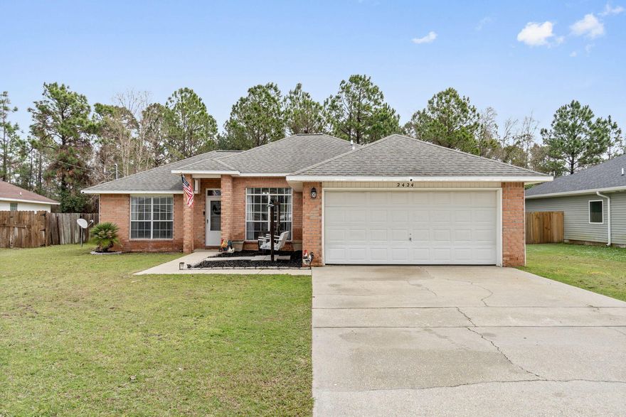 Welcome home to this lovely east Navarre retreat situated on a cul-de-sac street on over a quarter acre lot. Featuring 3 bedrooms and 2 bathrooms you're going to adore this tastefully updated and move-in ready home perfectly located to schools, sports, complexes, Navarre Beach, restaurants, and a short commute to Hurlburt Field! Pull into the driveway and appreciate the brick entry and tasteful landscaping, and enter insight to appreciate the newly installed luxury vinyl plank flooring that extends throughout the entire house (no carpet!). The split floor plan features an owner's suite on the left side of the house complete with double vanities, two walk in closets, a walk in shower and separate soaking tub. There is a vaulted ceiling in the living room and you'll love having a formal dining room space (or flex space) as well as an eat in kitchen area. The kitchen is adorned with black stainless appliances and new hardware, as well as a new updated sink, and there is also a pantry. The other two bedrooms are located on the other side of the house and feature ample closet space and there is a full bathroom between them. The interior laundry room leads to the two car garage, and you'll love your fully privacy fenced in back yard with no neighbors behind you! Chicken coop can convey and a property survey is available for a buyer's use. Roof, water heater, and HVAC system were all replaced in 2016. (more exterior photos coming Monday)