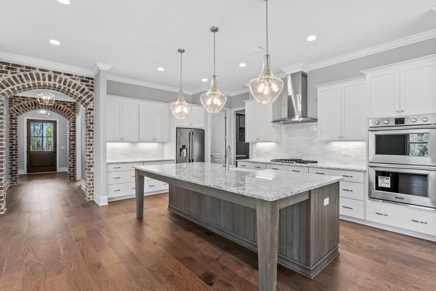 Beautiful luxury home by locally renowned builder in Hammock Bay Vineyards.  Gated community within Hammock Bay, our areas best Master Planned community.  This home features an oversized homesite that is almost a half acre in size.  Great yard for a pool!!  Outdoor living at its best with a rear covered porch that features over 800 square feet of living space and a full outdoor kitchen.  Interior of the home features Cambria quartz counter tops, professional grade stainless appliances, and furniture grade cabinetry.  Wood floors throughout entry, living and master suite.  Custom tile to ceiling and floors in all bathrooms.  Master bedroom has two walk in closets.  Mudroom with cabinets.  2.5 car garage.  Ready for move in April!!