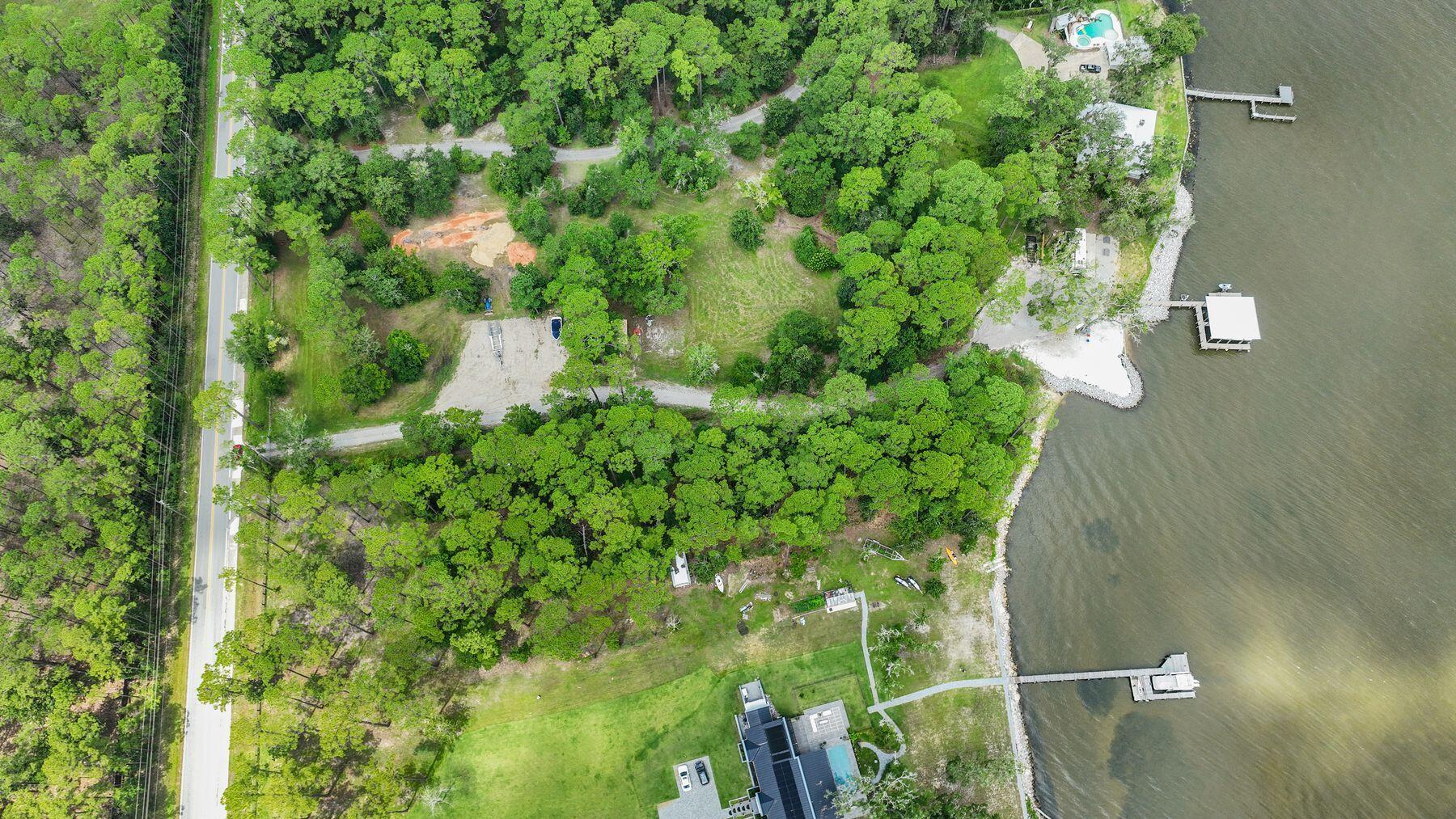 A Bayfront Statement Estate Opportunity | 2 Acres on Choctawhatchee Bay | TBD Chat Holly RoadFor those who demand more than just a waterfront lot--this is your blank canvas to command the bay.Situated on over 2 acres of prime, bayfront property along the serene curve of Choctawhatchee Bay, this is not merely land--it's a rare stage to craft your legacy. With over 150 feet of private waterfront, expansive elevation, and deep setbacks from the road, this estate-sized parcel offers the ultimate in privacy, presence, and potential.Design the kind of bespoke compound most only glimpse from a passing boat. Build a private dock to accommodate your collection--from shallow skiffs to sportfishers and beyond--and still have room to spare for a guest house, car barn, or pool pavilion.