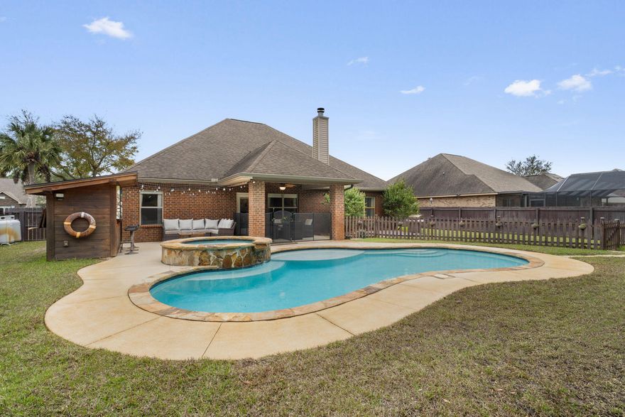 Stunning pool home in the highly sought-after community of Grand Bay Estates offering the perfect blend of comfort, style, and coastal lifestyle. This beautifully maintained 4-bedroom, 2.5-bath residence also features a formal dining room, private office, a spacious bonus room and a 2-car garage, providing both flexibility and functionality.The home welcomes you with a bright open floor plan filled with natural light and freshly painted interiors. The expansive living area with a cozy fireplace flows seamlessly into the heart of the home -- a beautiful chef's kitchen featuring new trendy granite countertops, soft-tone cabinetry, stainless steel appliances, a large pantry, and abundant cabinet space, making it ideal for entertaining and everyday living. Elegant wood-look tile flooring extends throughout the main living areas, with ceramic tile in the wet spaces. All bathrooms feature updated granite countertops, adding a cohesive and upscale touch. Recent improvements include a newer dishwasher, gutters, AC system, and hot water heater.Step outside and discover your private backyard sanctuary. The spectacular gunite ozone-heated pool with spa and waterfall creates a true resort atmosphere, complemented by a tiki bar, sundeck, and fire pit--perfect for entertaining or relaxing under the Florida sun. Lush landscaping with crape myrtles, azaleas, vitex, birds of paradise, bottlebrush, and knockout roses surrounds the beautifully manicured grounds, offering both privacy and natural beauty. Residents of Grand Bay Estates enjoy sidewalk-lined streets, street lamps, and deeded bay access with a dock for fishing, kayaking, and swimming, while remaining conveniently close to schools, shopping, dining, and the stunning white-sand beaches of the Emerald Coast.  Additional highlights include a sprinkler system, termite bond, and transferable home warranty for added peace of mind.
A rare opportunity to enjoy luxury, privacy, and the relaxed coastal lifestyle Navarre is known for.