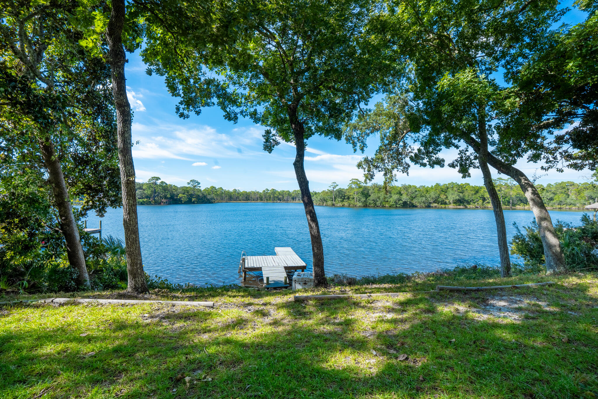 Fully Renovated Waterfront Retreat - 113 Ft of Shoreline w/ dock. This stunning waterfront home has been completely renovated offering modern luxury with timeless style. The gourmet kitchen was rebuilt down to the studs and features Amish handcrafted maple cabinets, quartzite countertops, a massive island, and all-new Frigidaire appliances. Bathrooms are fully remodeled with custom cabinetry, Schluter system tile showers, Delta fixtures, and lighted mirrors. Interior upgrades include new oak engineered hardwood floors, fresh paint, new doors and trim, expanded closet space, custom shelving, new ceiling fans, and all new lighting. New roof (CertainTeed Pro 40-year shingles), full plumbing repipe, new HVAC, mini-split, hot water heater, and extensive electrical updates. Move-in ready!!
