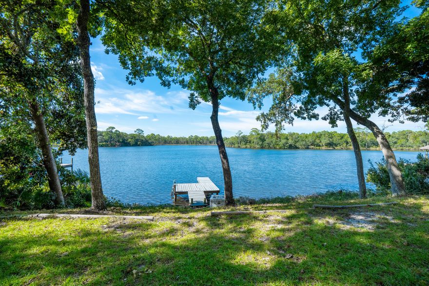 Fully Renovated Waterfront Retreat - 113 Ft of Shoreline w/ dock. This stunning waterfront home has been completely renovated offering modern luxury with timeless style. The gourmet kitchen was rebuilt down to the studs and features Amish handcrafted maple cabinets, quartzite countertops, a massive island, and all-new Frigidaire appliances. Bathrooms are fully remodeled with custom cabinetry, Schluter system tile showers, Delta fixtures, and lighted mirrors. Interior upgrades include new oak engineered hardwood floors, fresh paint, new doors and trim, expanded closet space, custom shelving, new ceiling fans, and all new lighting. New roof (CertainTeed Pro 40-year shingles), full plumbing repipe, new HVAC, mini-split, hot water heater, and extensive electrical updates. Move-in ready!!